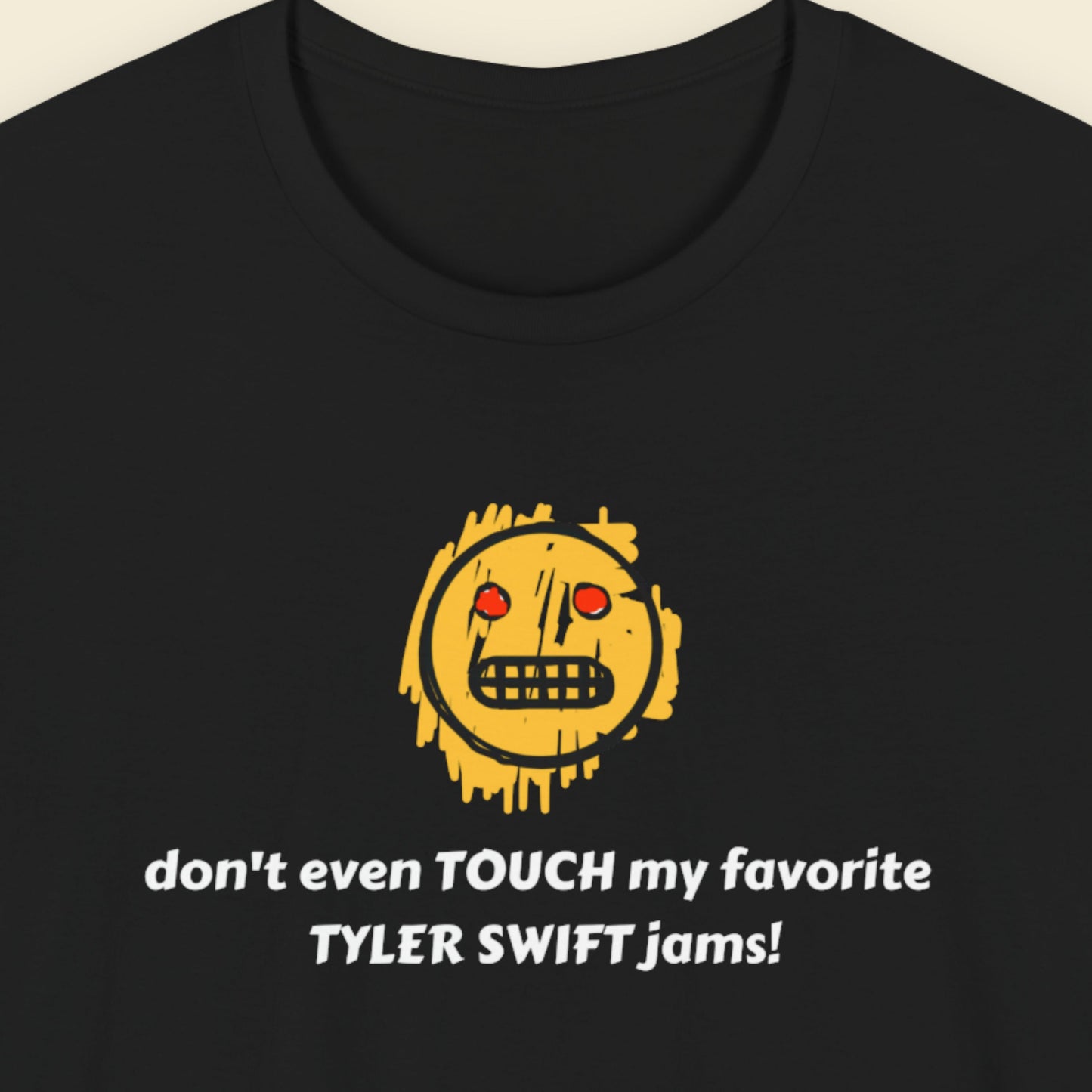 Black t-shirt with a yellow graphic and text on a beige background.