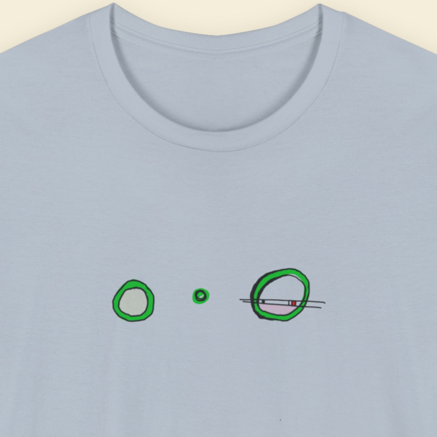 Blue t-shirt with a colorful abstract drawing on a beige background.