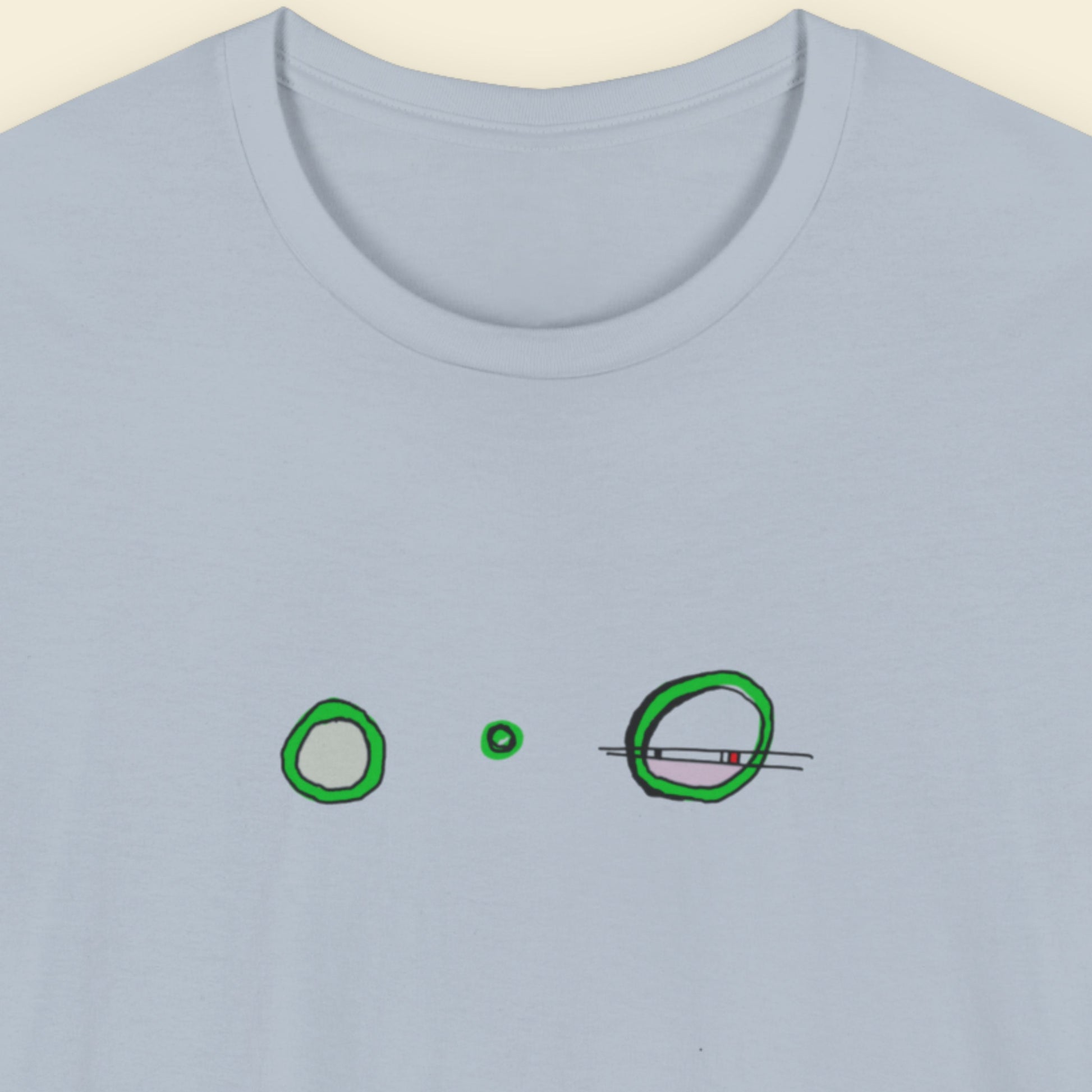 Blue t-shirt with a colorful abstract drawing on a beige background.