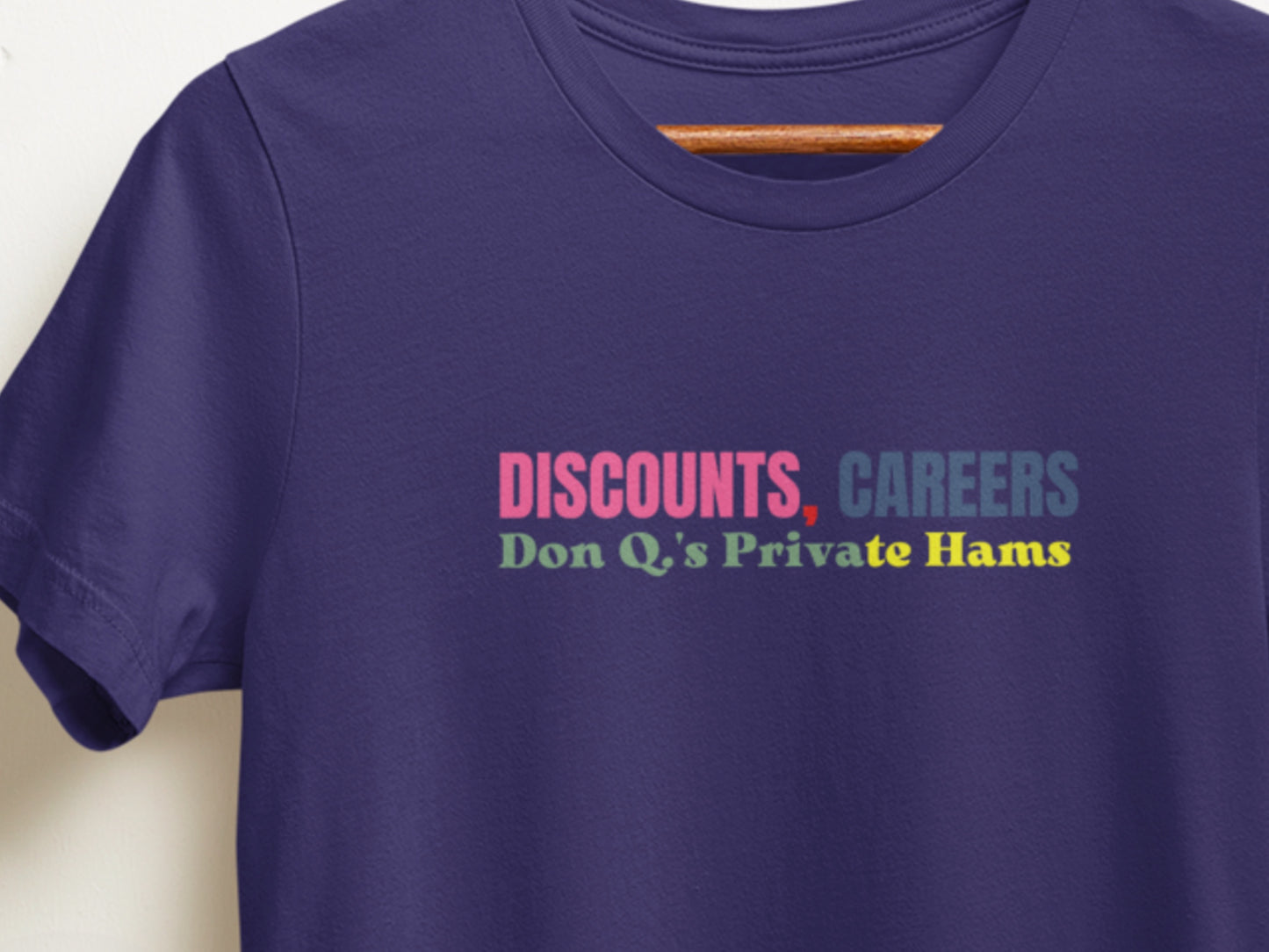 Navy t-shirt with colorful text on a white background