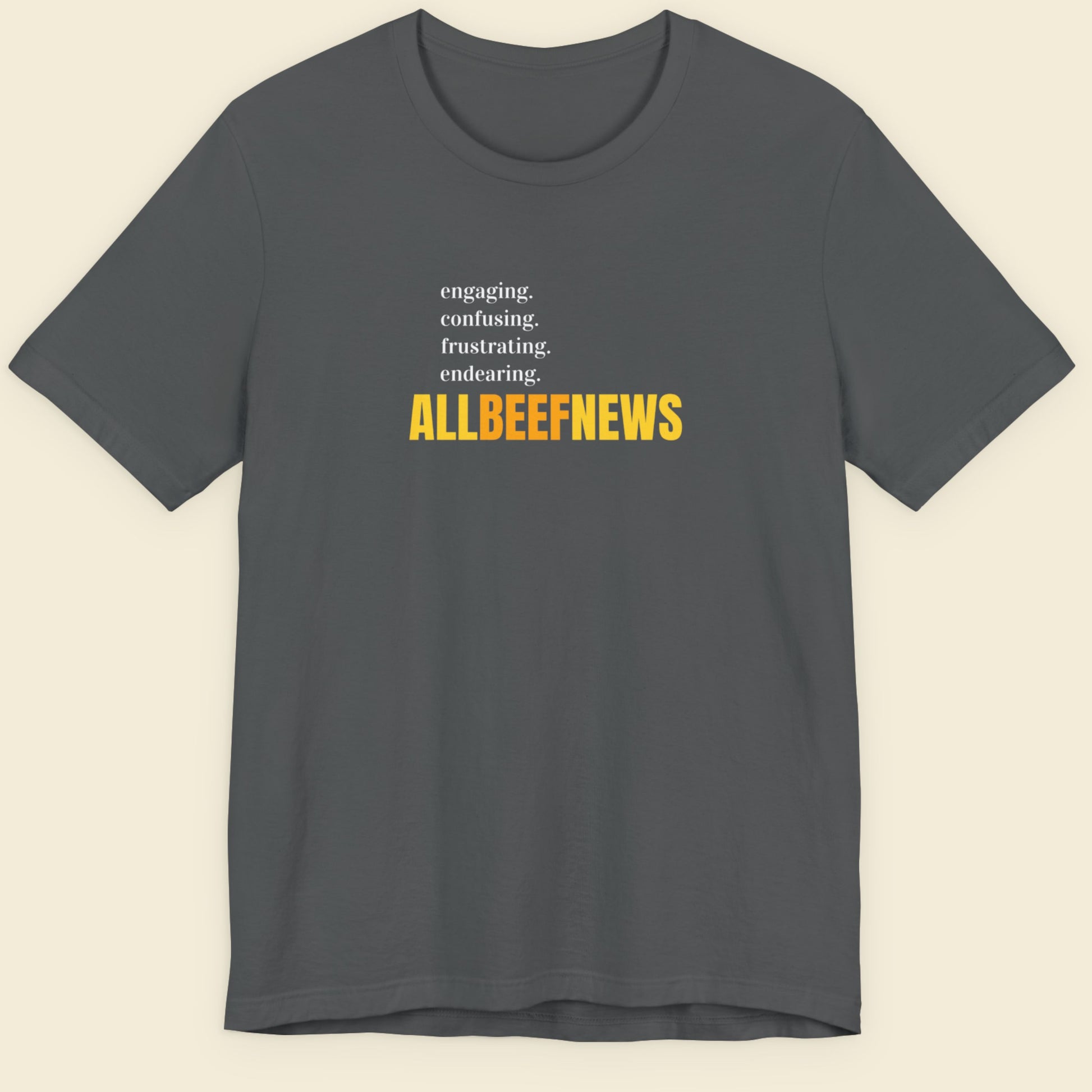 Dark grey t-shirt with humorous nonsensical colorful text on a beige background.