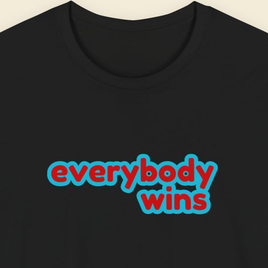 Black t-shirt with multicolored everybody wins' text on a beige background.