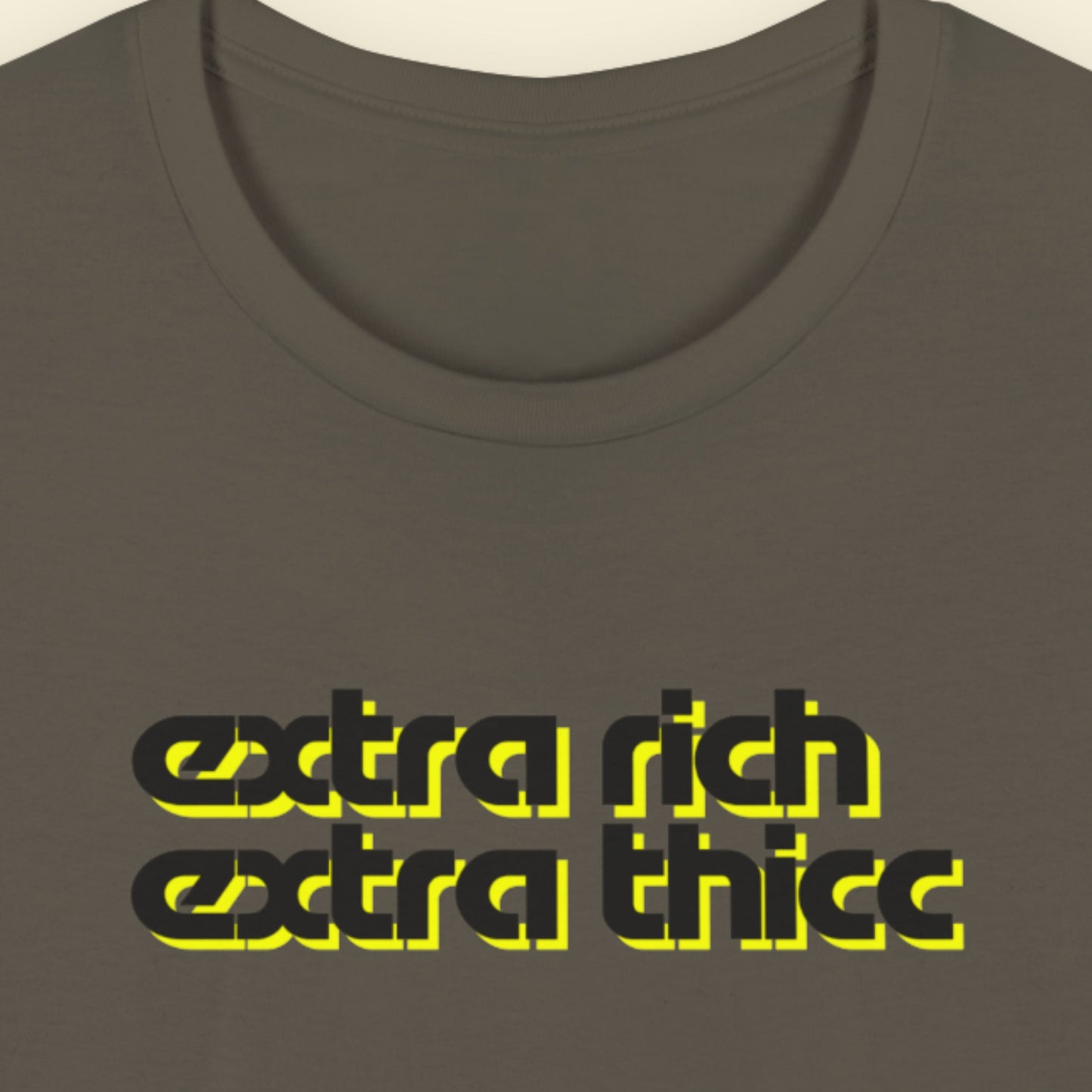 Army green t-shirt with 'extra rich extra thicc' text in black and yellow on a beige background.