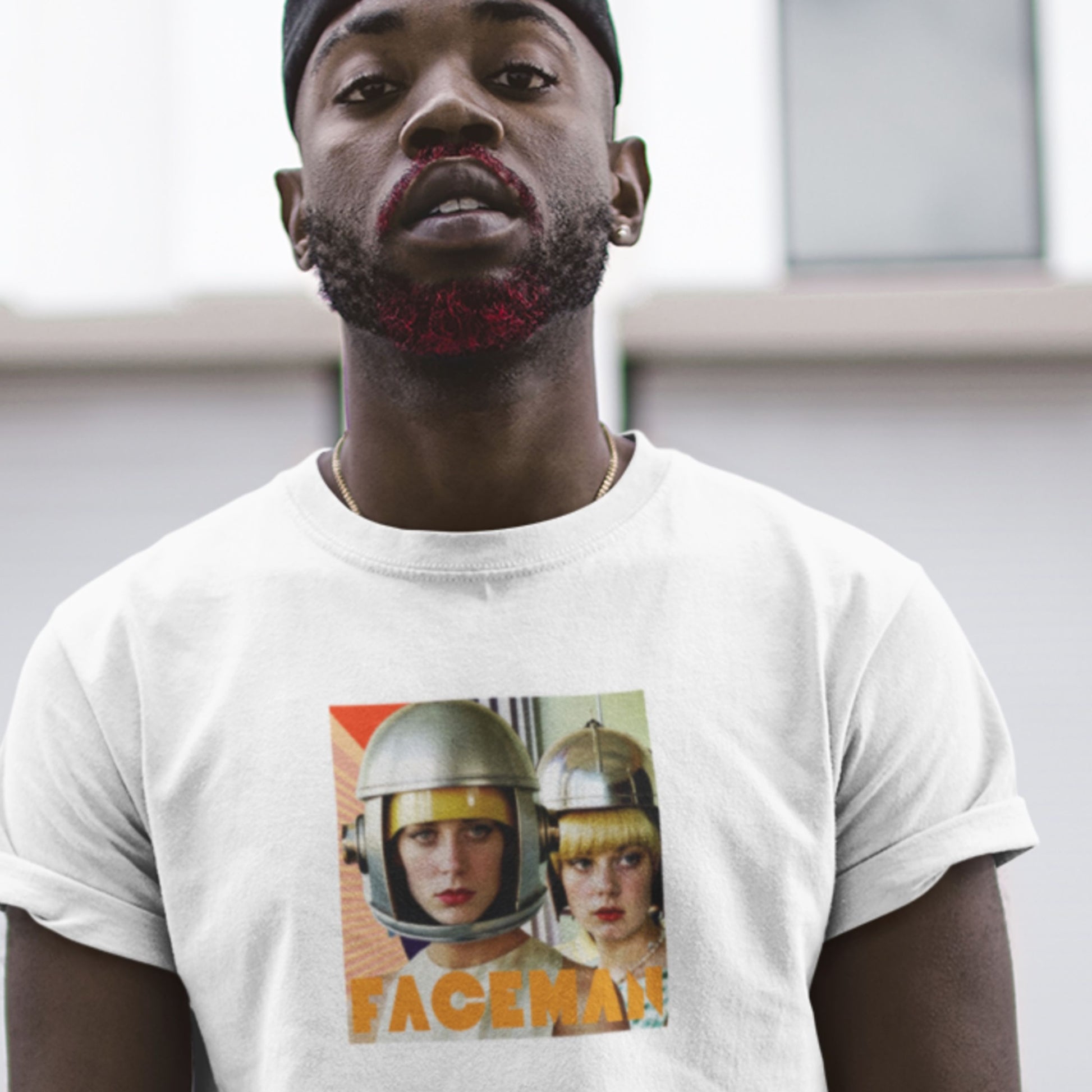 Man wearing a white t-shirt with 'Faceman' graphic design