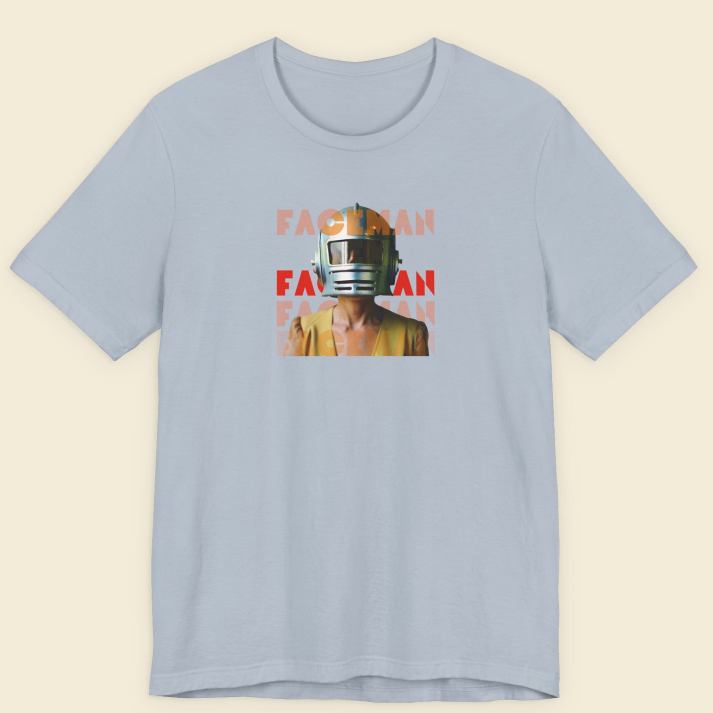 Light blue t-shirt with a graphic of a person wearing a helmet and 'FACEMAN' text on a beige background