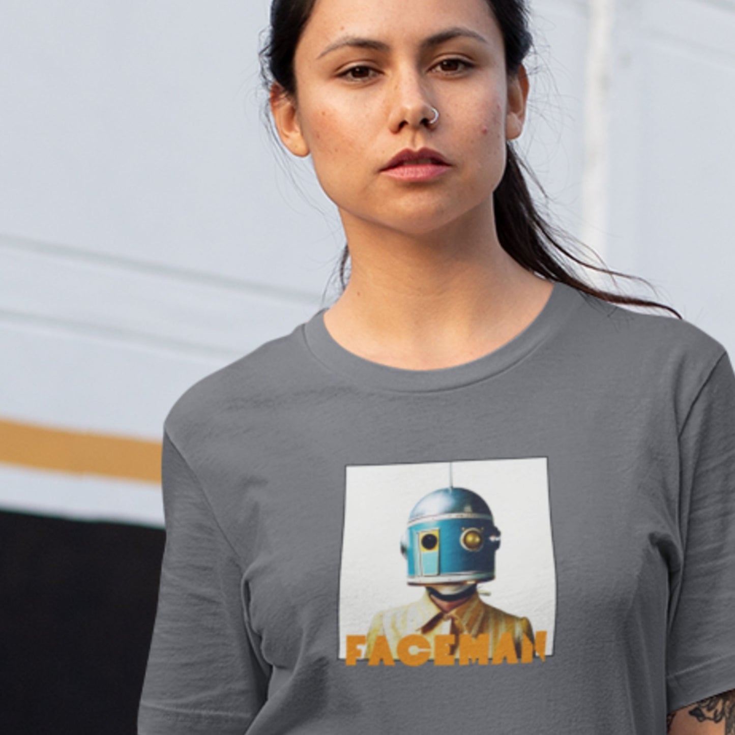 Model wearing an asphalt grey shirt featuring an image of a helmet wearing woman as Faceman, famous space musician