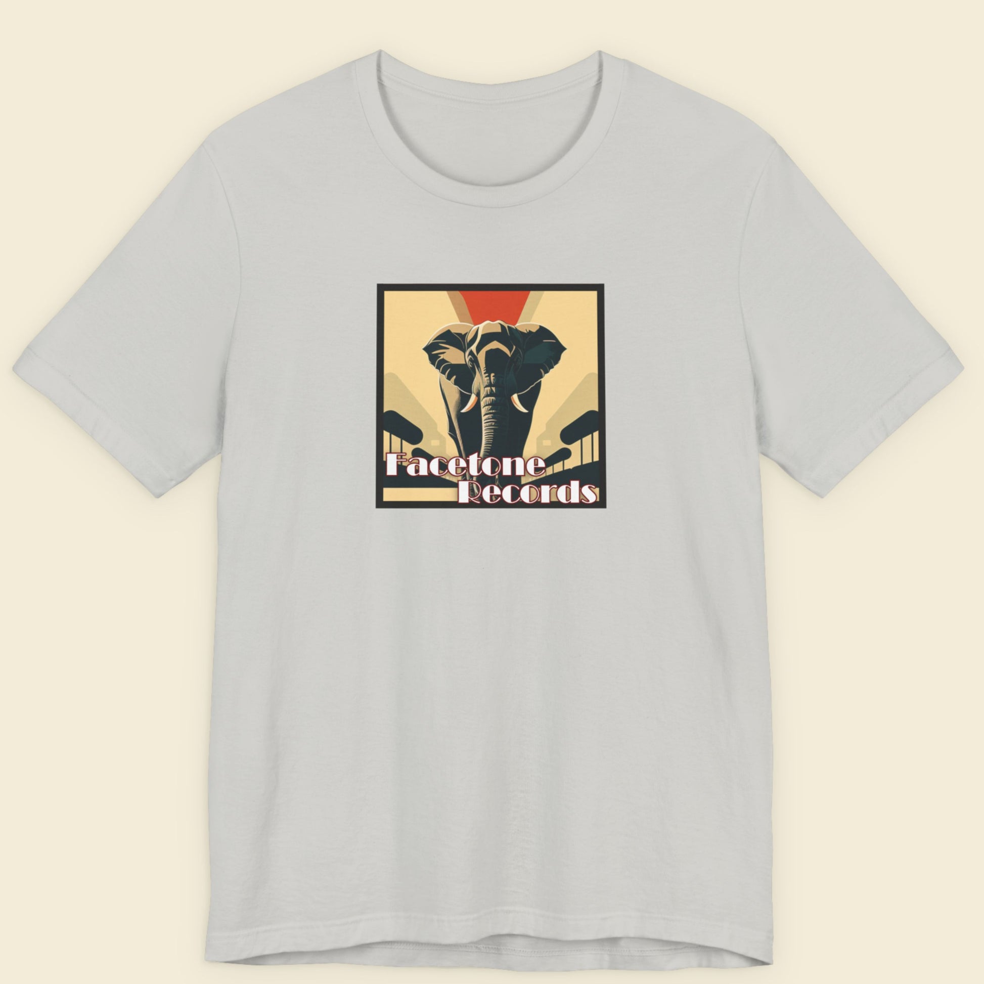 Light gray t-shirt with a graphic design of an elephant and text on a beige background