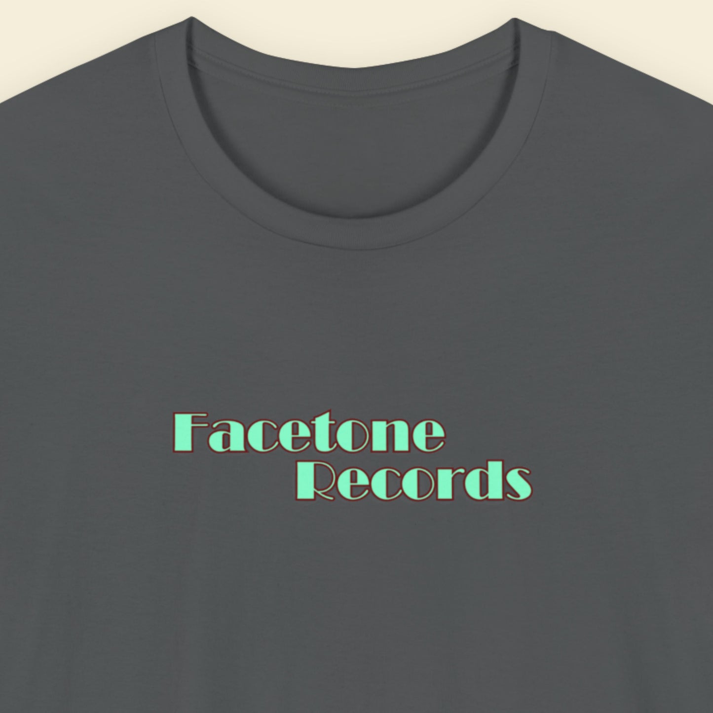 Gray t-shirt with 'Facetone Records' text in green on a beige background