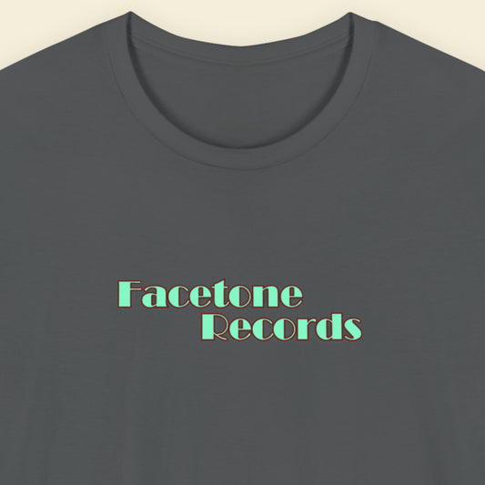 Gray t-shirt with 'Facetone Records' text in green on a beige background
