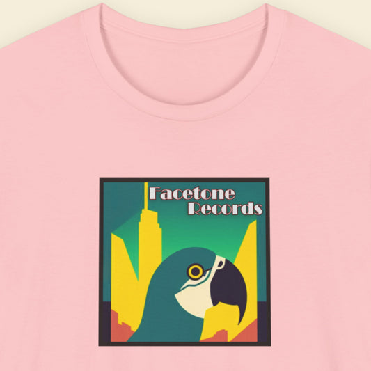 Pink t-shirt with a graphic design featuring a macaw and 'Facetone Records' text on a beige background