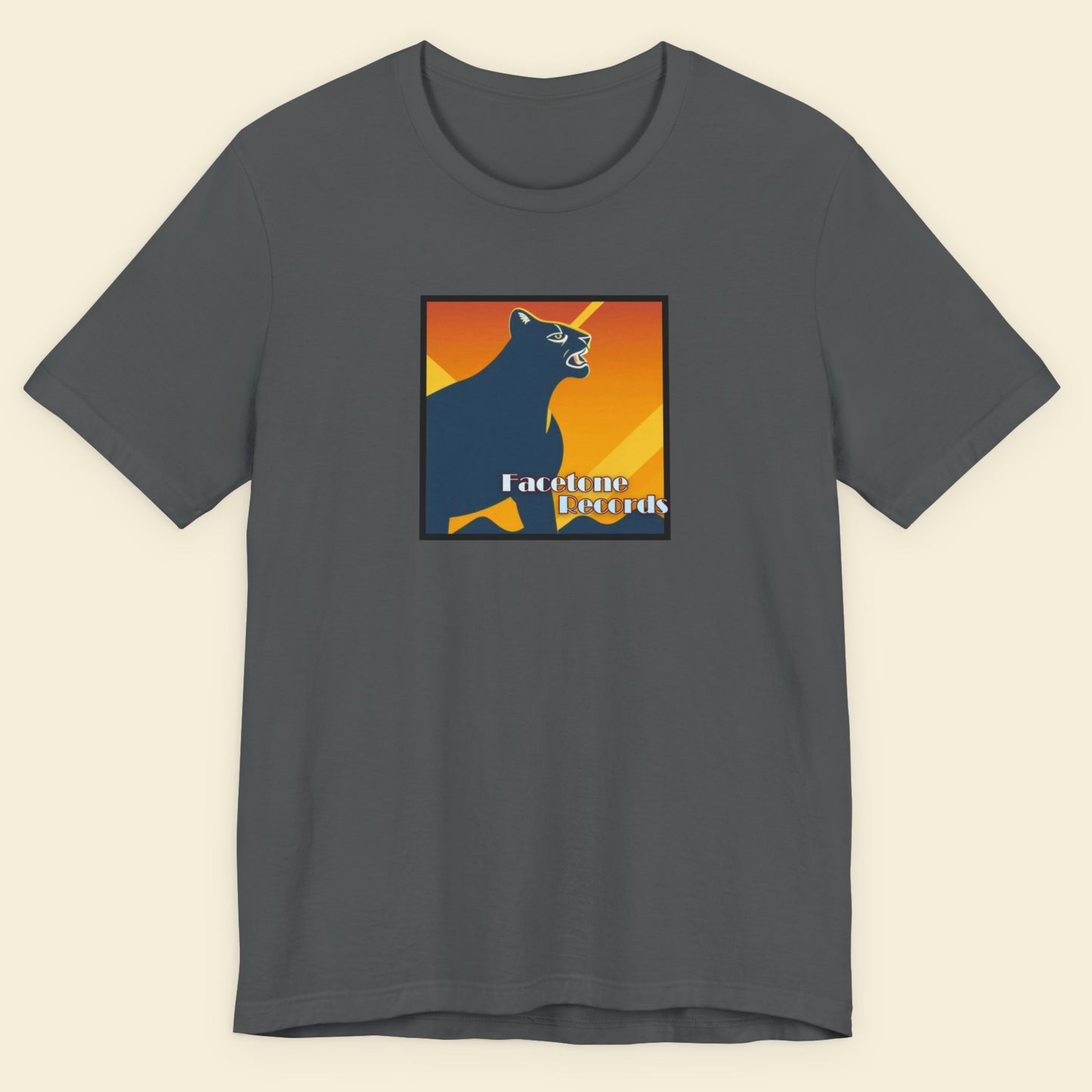 Gray t-shirt with a colorful graphic of a panther on a beige background