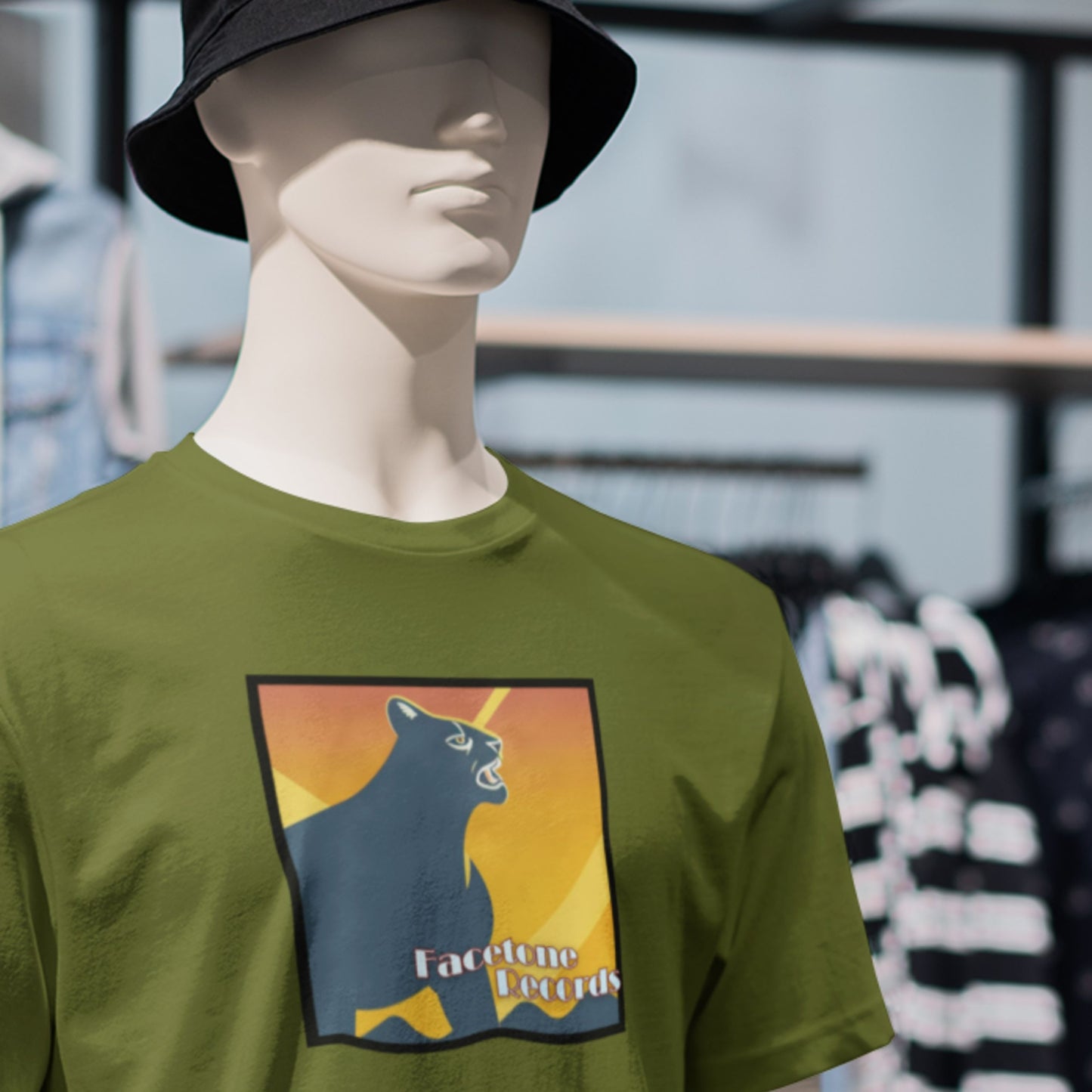 Mannequin wearing a green t-shirt with a mountain lion graphic design in a store setting