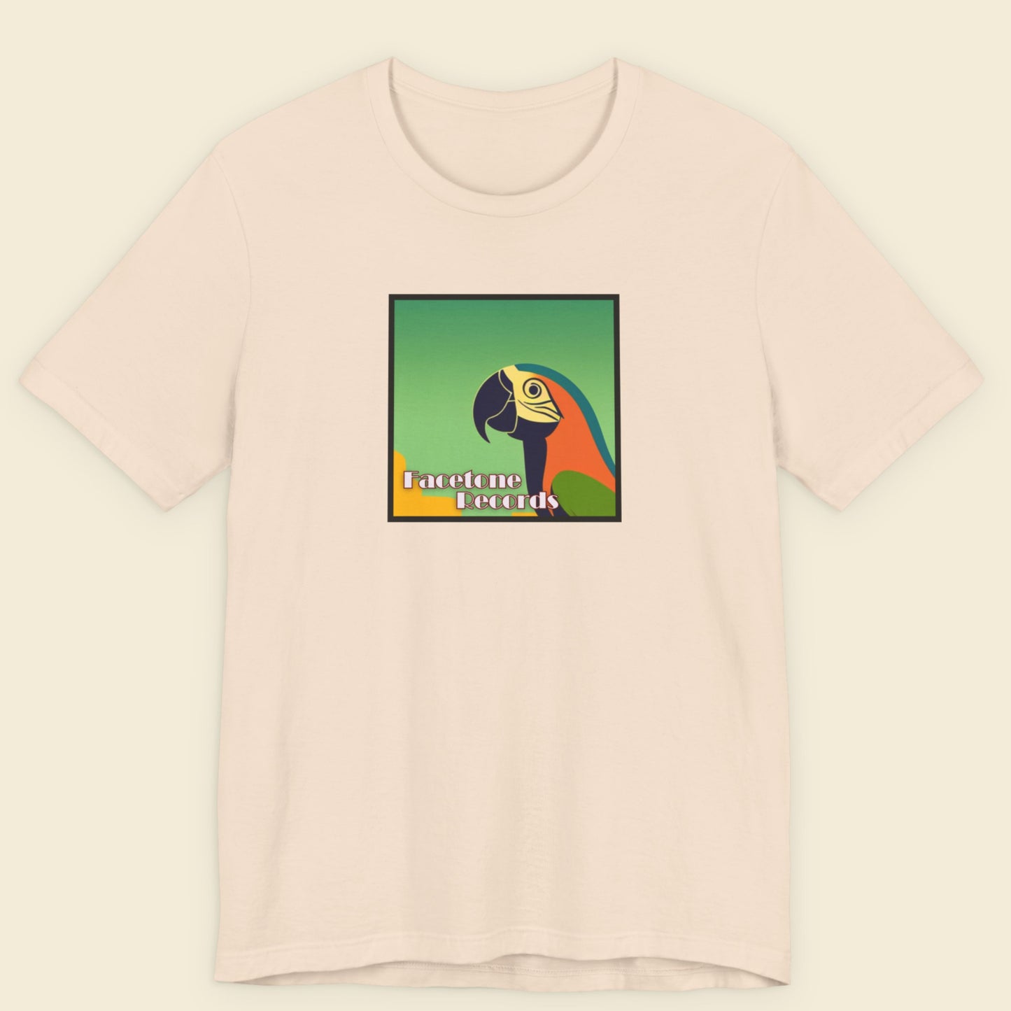 Pink t-shirt with a colorful parrot graphic and text on a beige background
