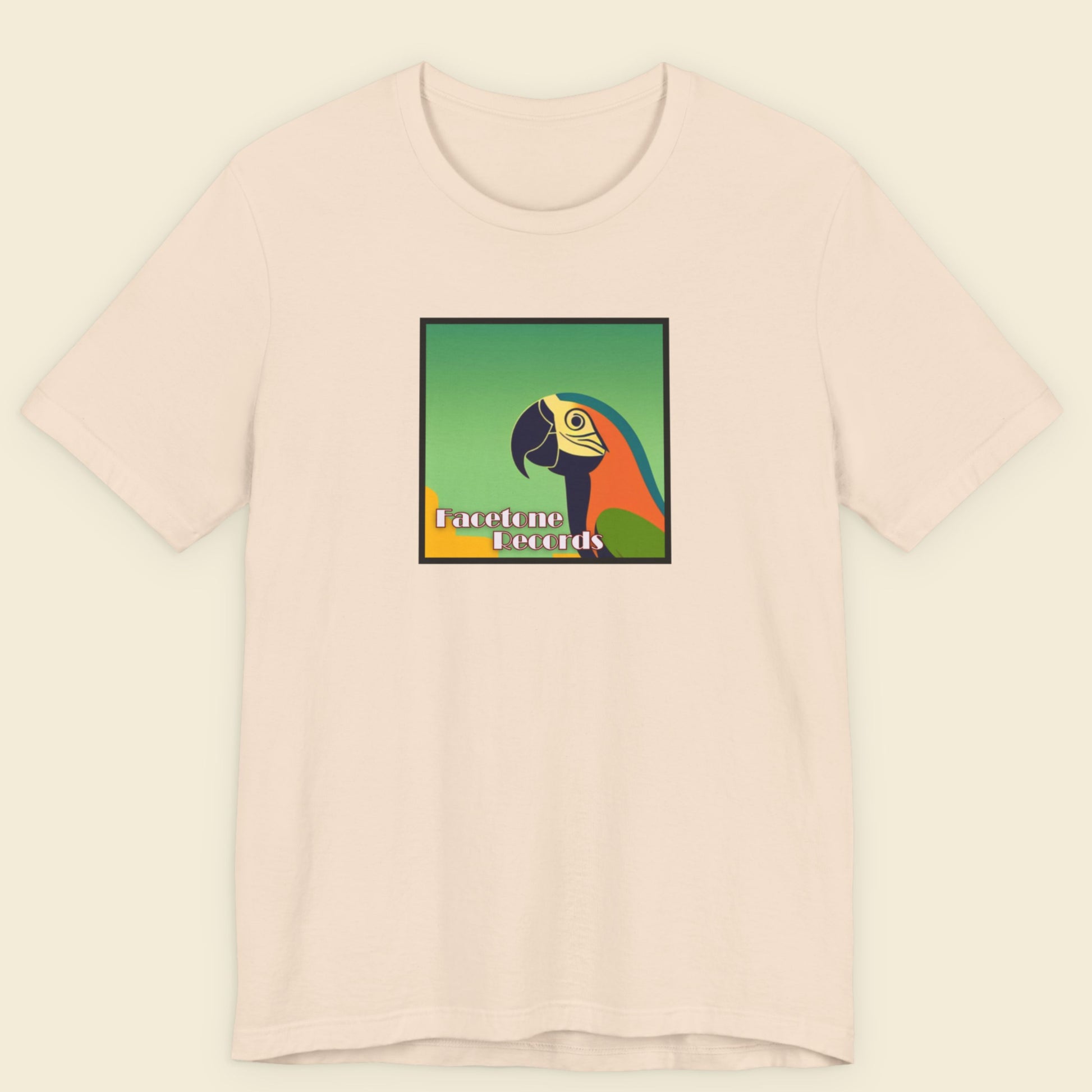Pink t-shirt with a colorful parrot graphic and text on a beige background