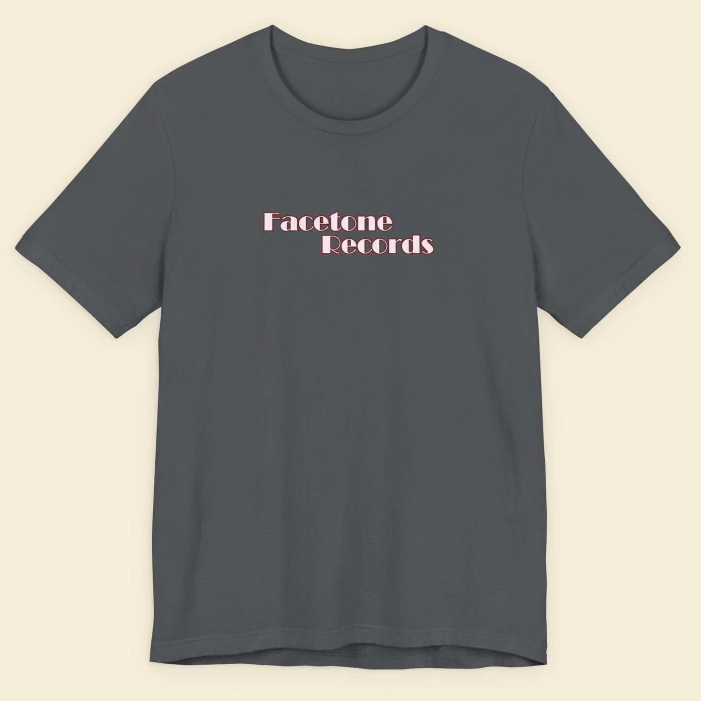 Gray t-shirt with 'Facetone Records' text on a beige background