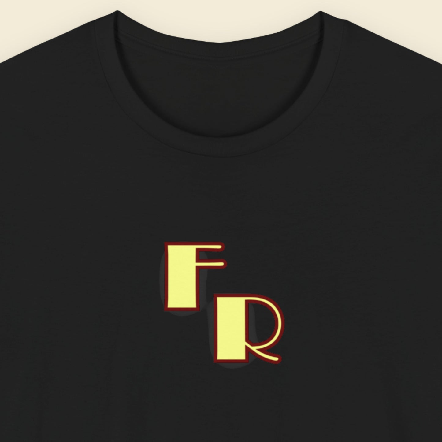 Black t-shirt with yellow 'FR' logo on a beige background