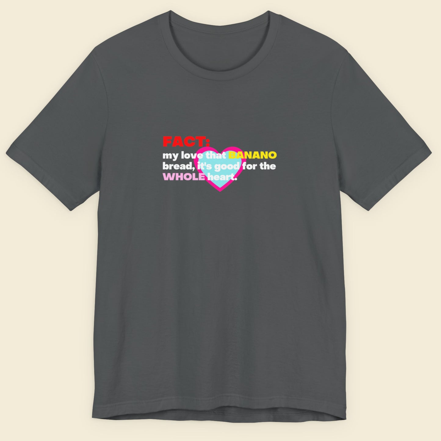 Gray t-shirt with colorful text design on a beige background.