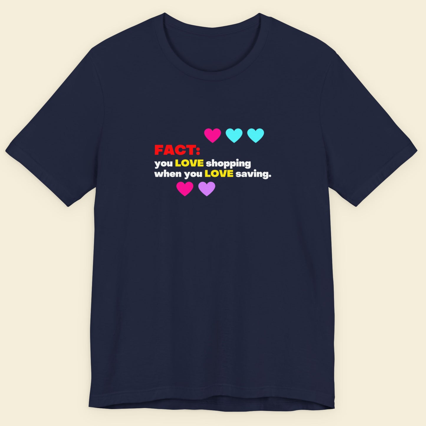Navy blue t-shirt with humorous colorful text on a beige background.