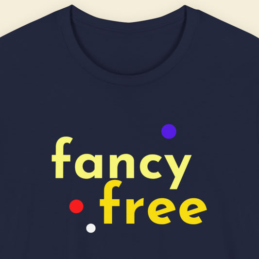 Navy blue t-shirt with 'fancy free' text in yellow and colorful dots on a beige background.