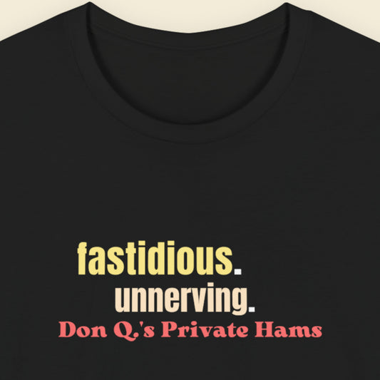 Black t-shirt with colorful text on a beige background.