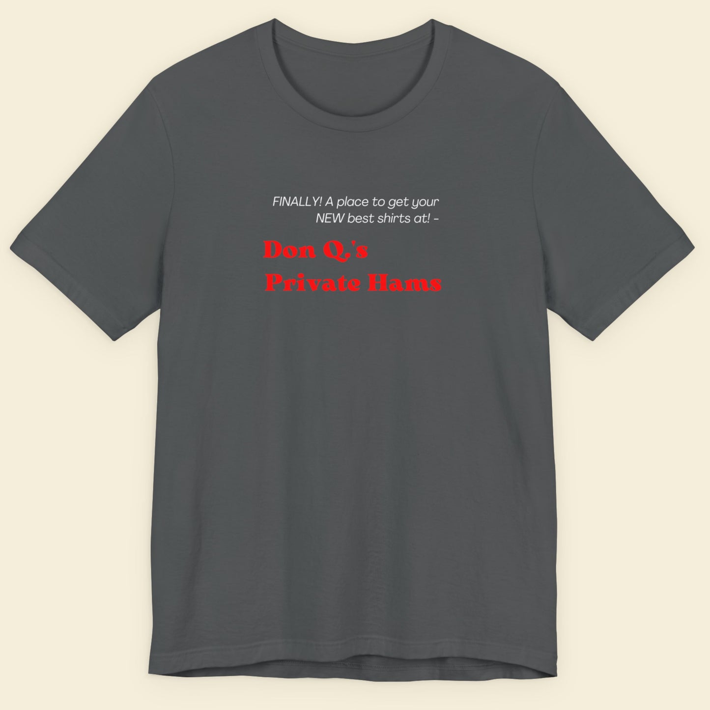 Gray t-shirt with text on a beige background.