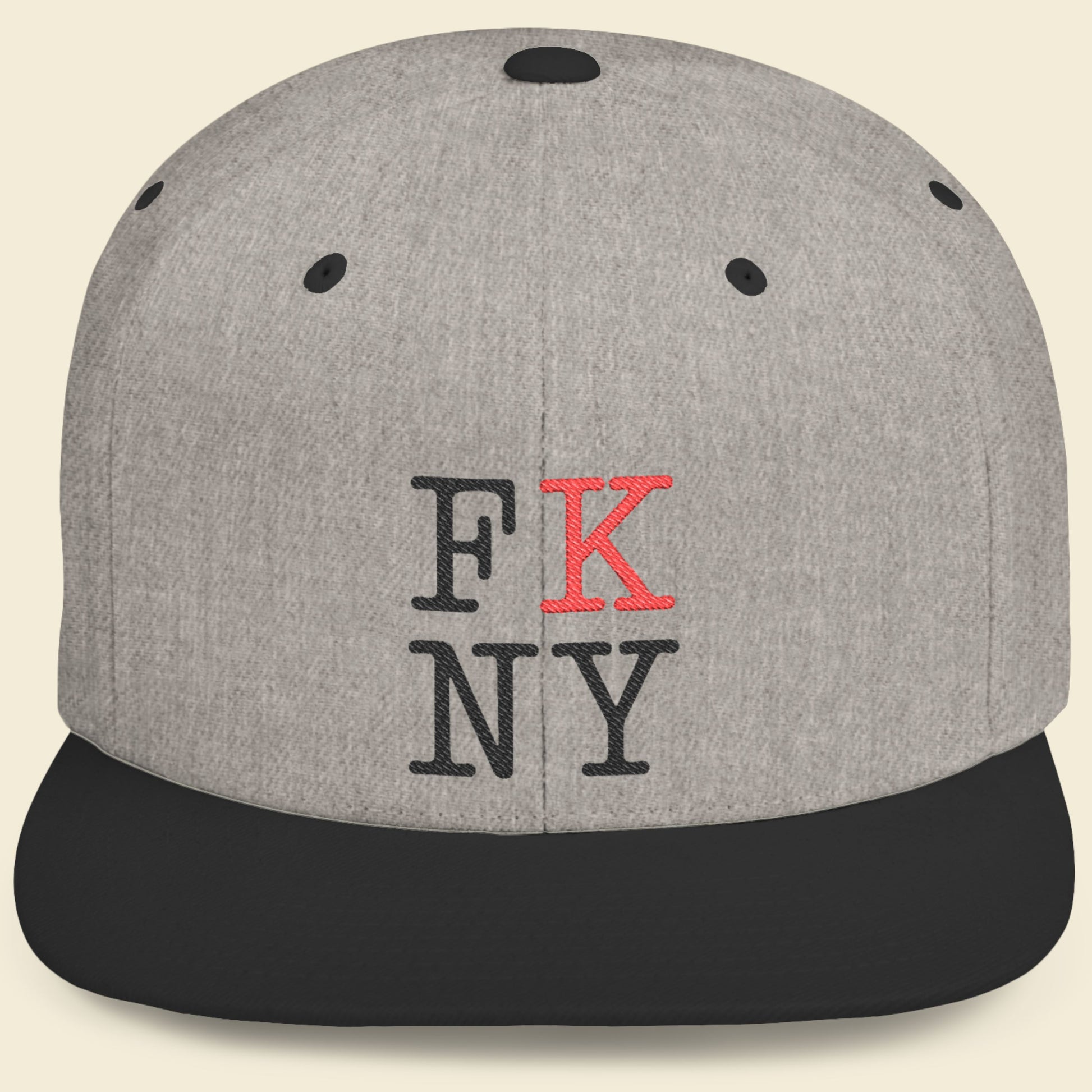 Gray cap with black and red FK NY text on a beige background.