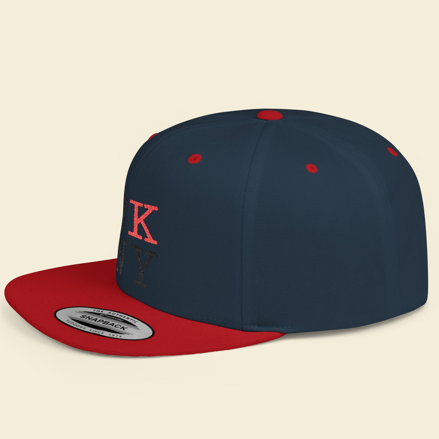 Navy and red cap with a FK NY logo on a beige background.
