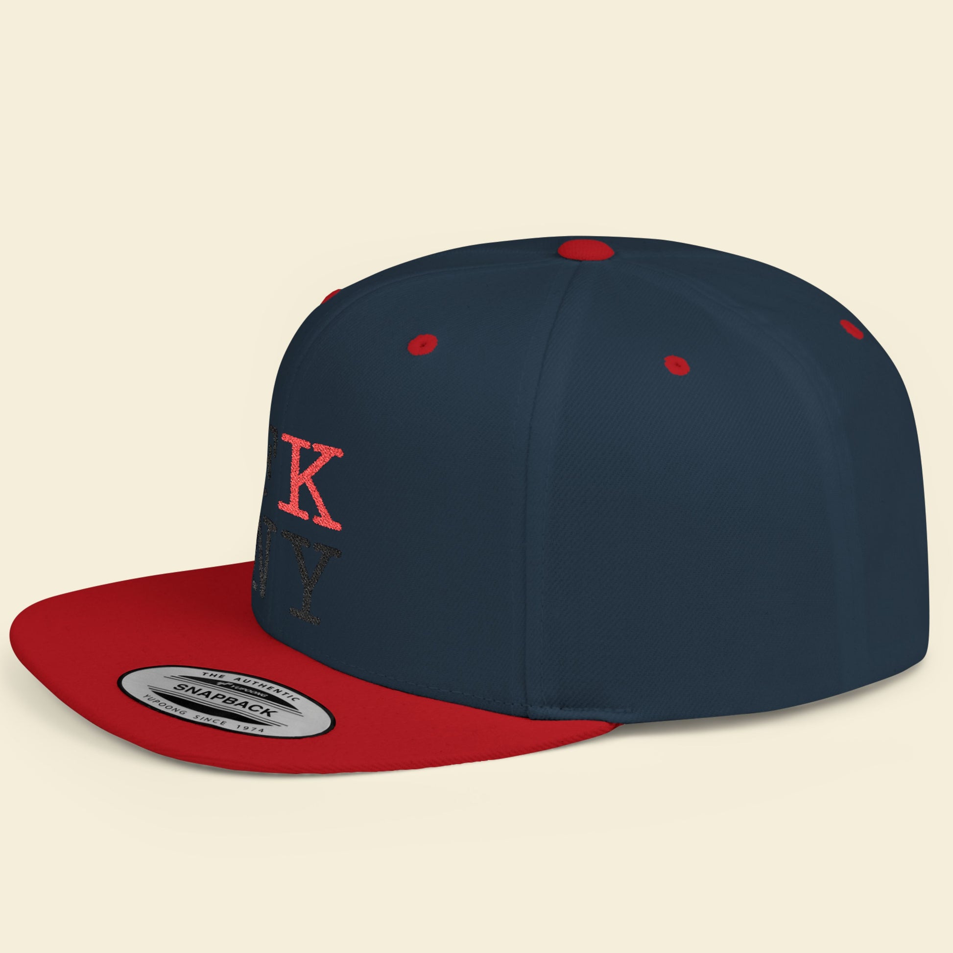 Navy and red cap with a FK NY logo on a beige background.