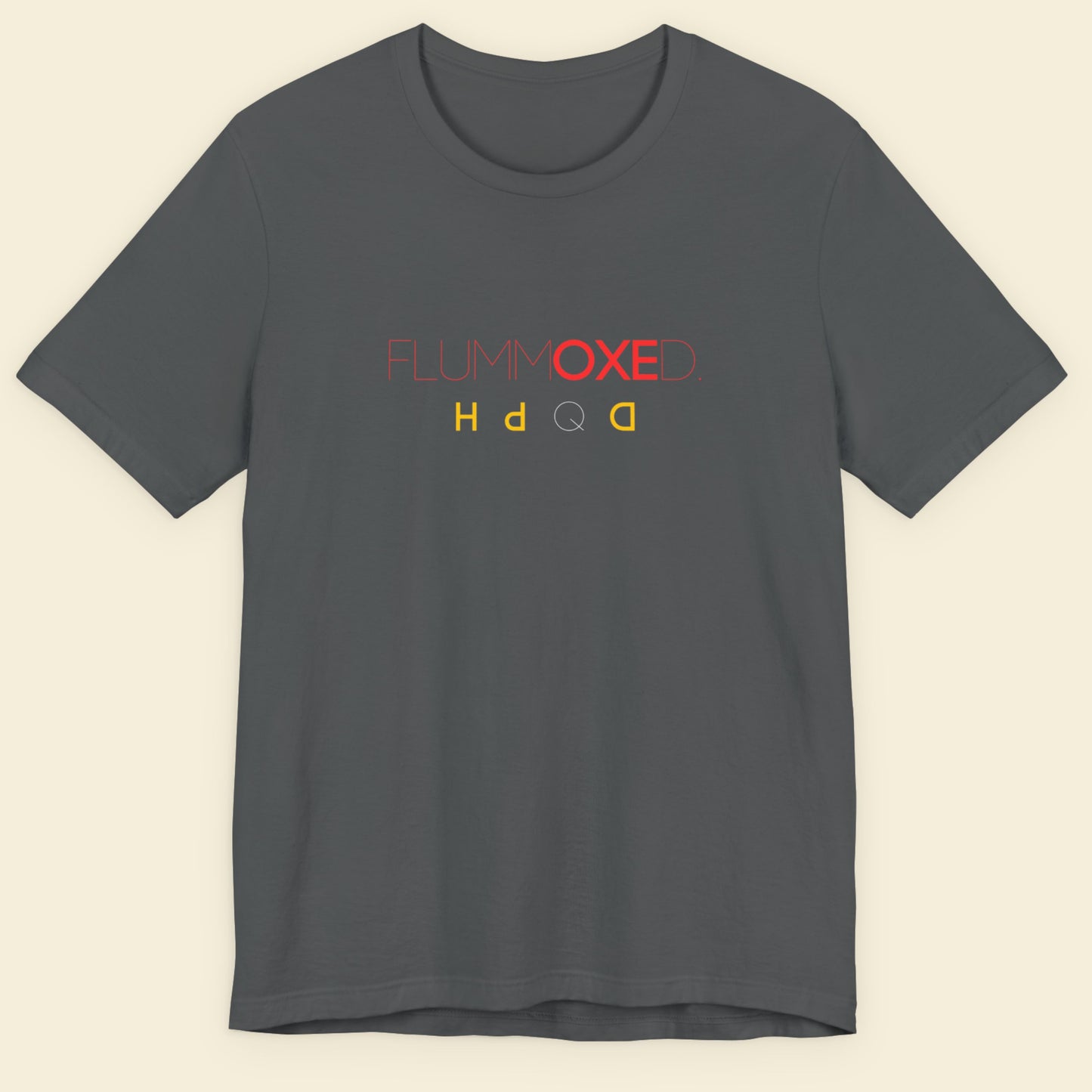 Gray t-shirt with colorful text design on a beige background.