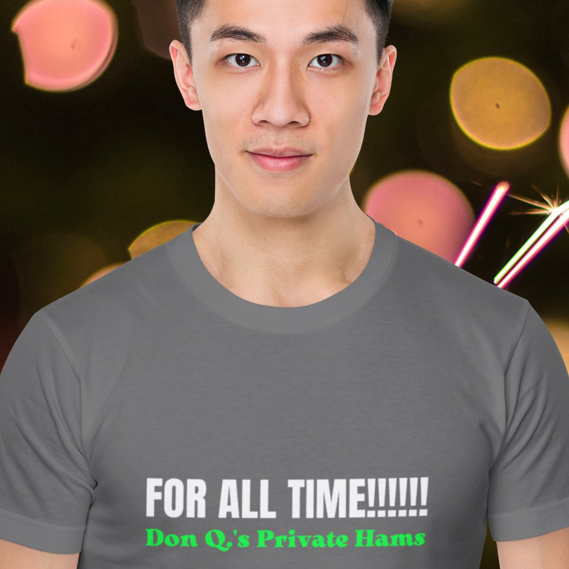 Man wearing a gray t-shirt with text in front of a blurred colorful background.