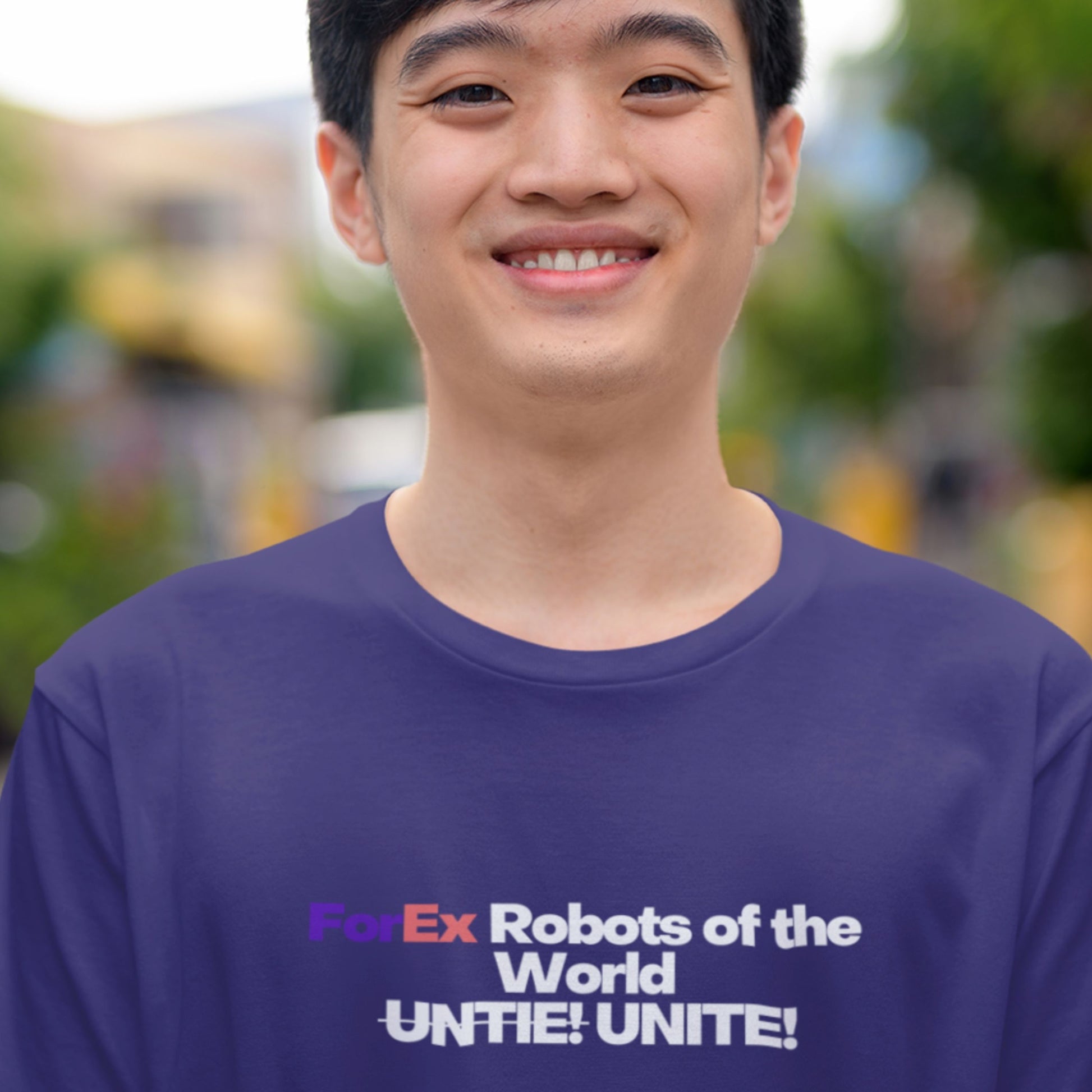Person wearing a blue t-shirt with text in an outdoor setting.