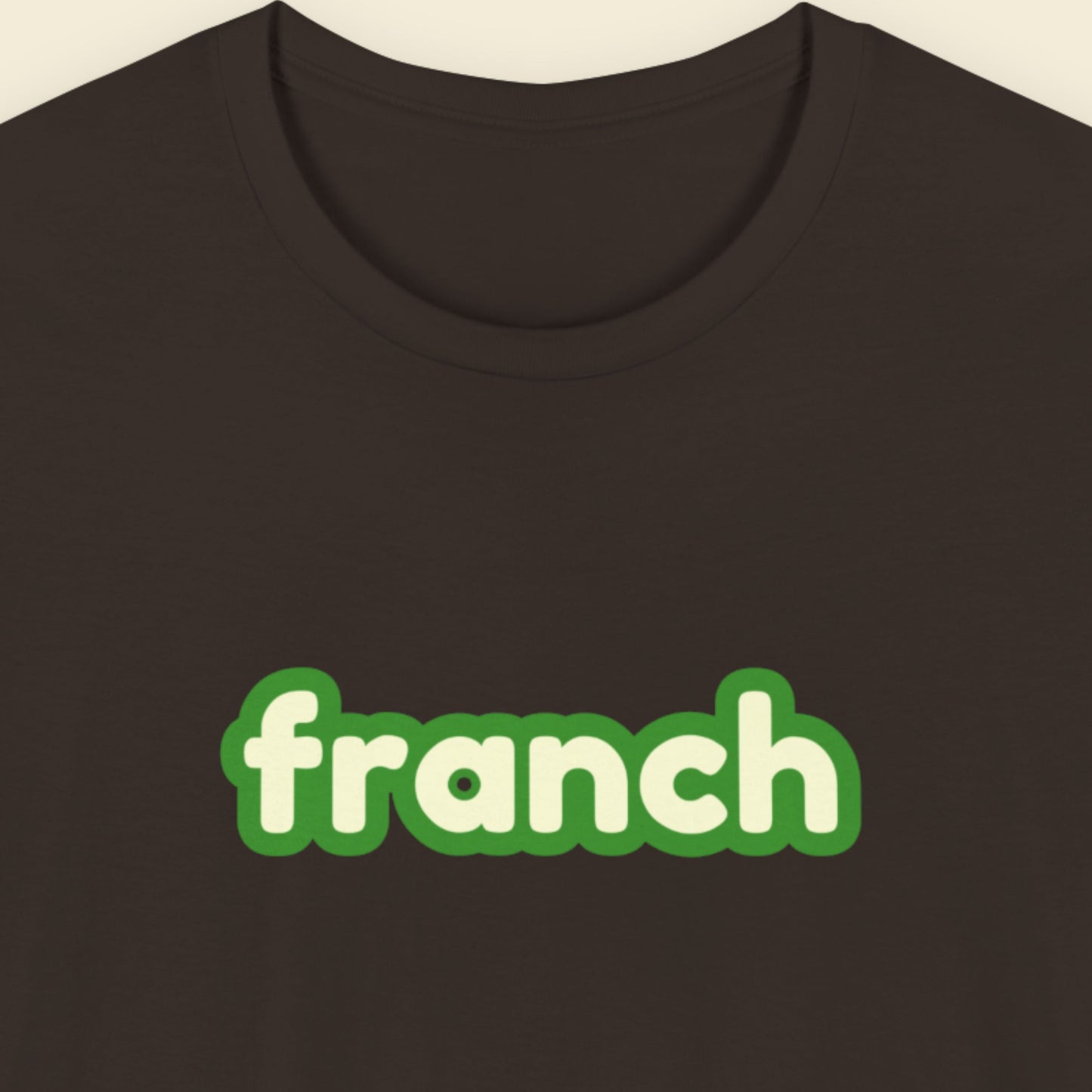 Brown t-shirt with humorous colorful text on a beige background.