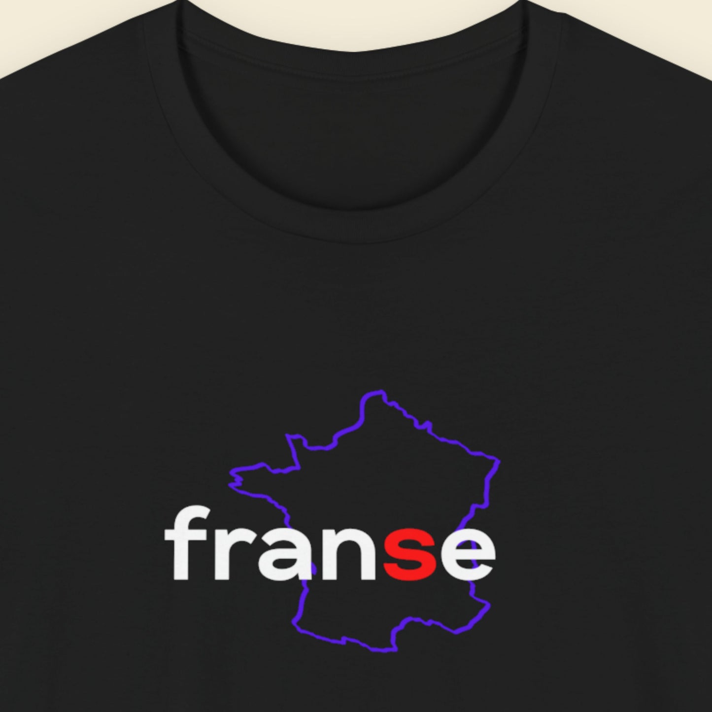 Black t-shirt with humorous colorful text on a beige background.
