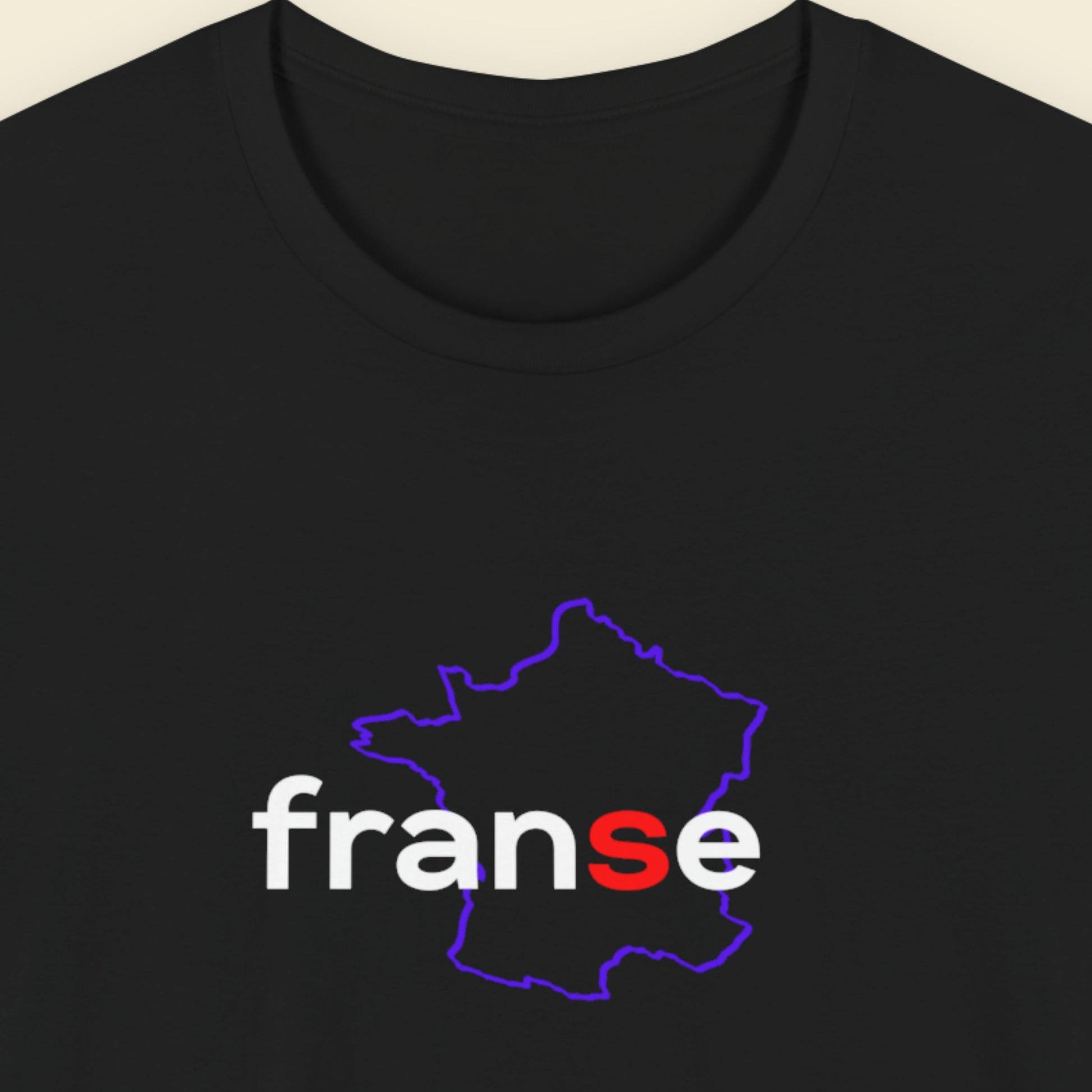 Black t-shirt with humorous colorful text on a beige background.