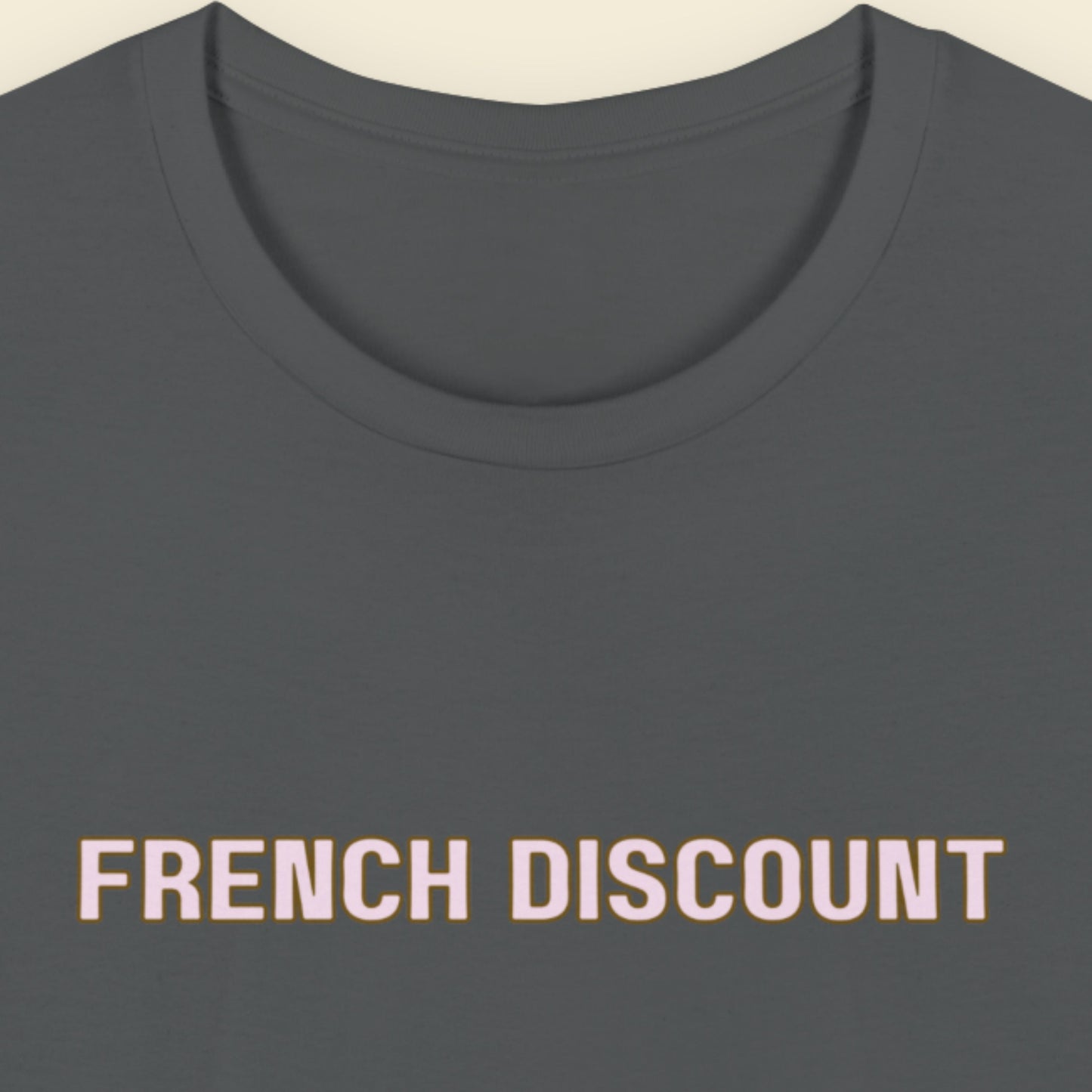 Grey t-shirt with humorous colorful text on a beige background.