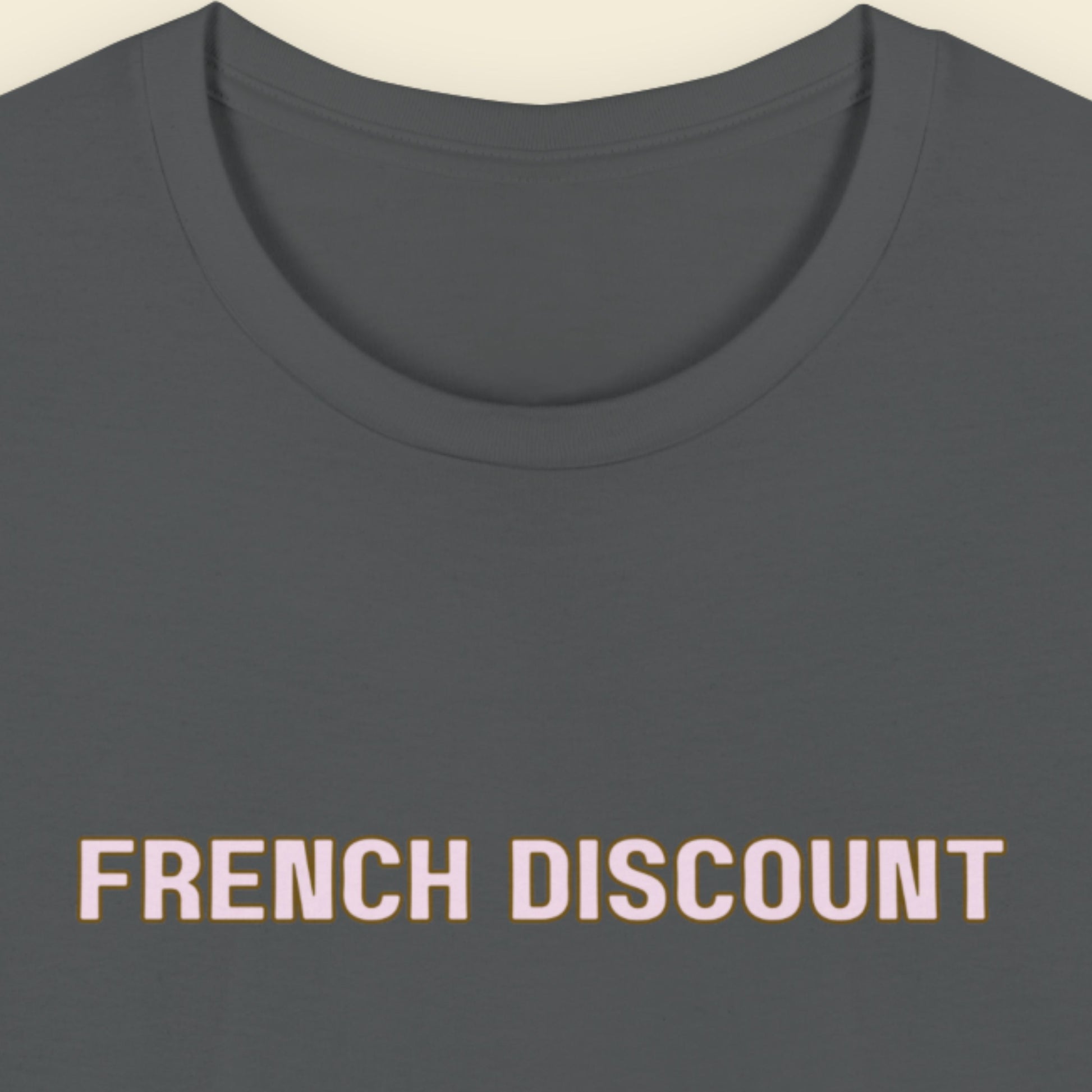 Grey t-shirt with humorous colorful text on a beige background.
