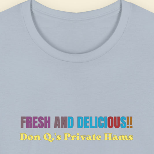 Light blue t-shirt with humorous colorful text on a beige background.