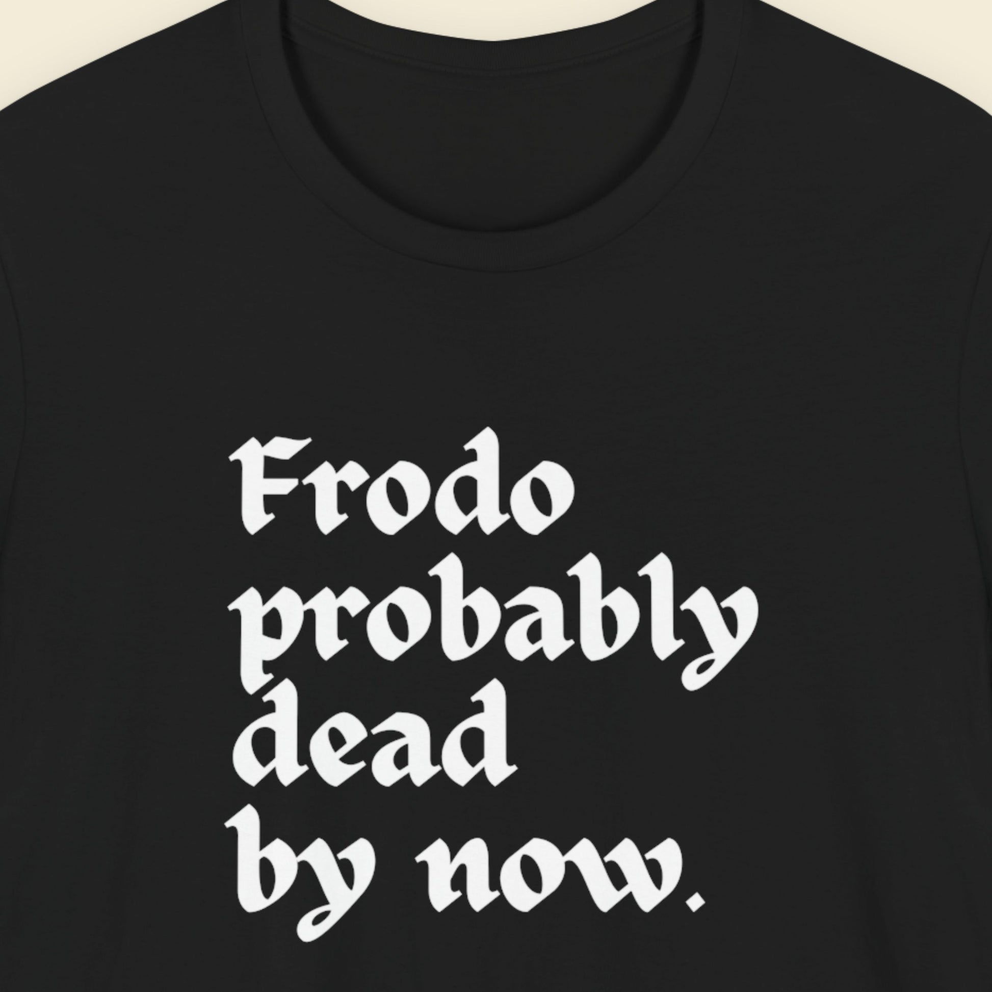 Black t-shirt with humorous LOTR text on a beige background.