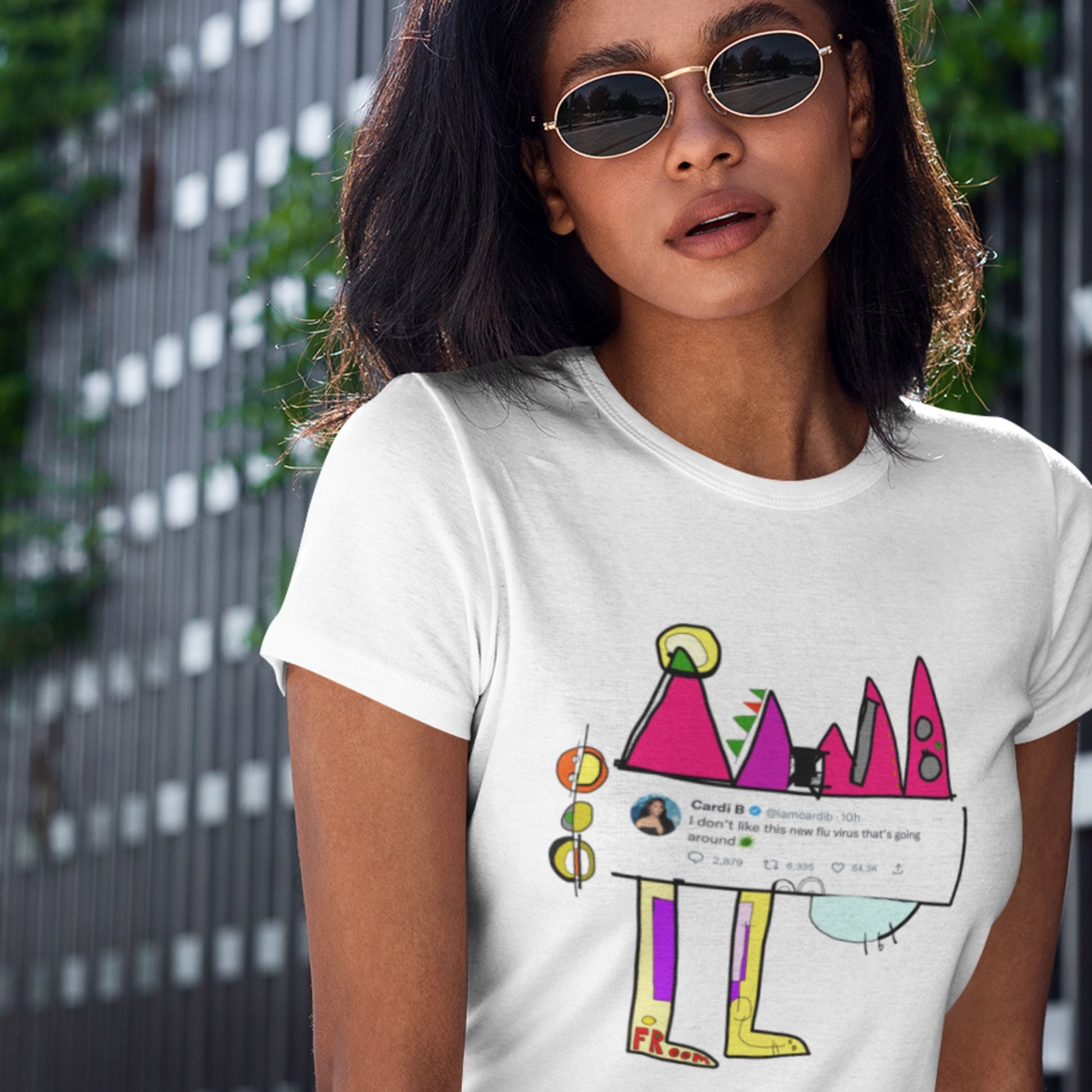 Person wearing a white t-shirt with a colorful graphic design.