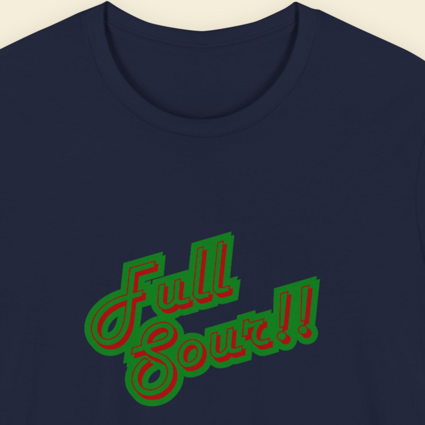 Navy t-shirt with colorful humorous text on a beige background.
