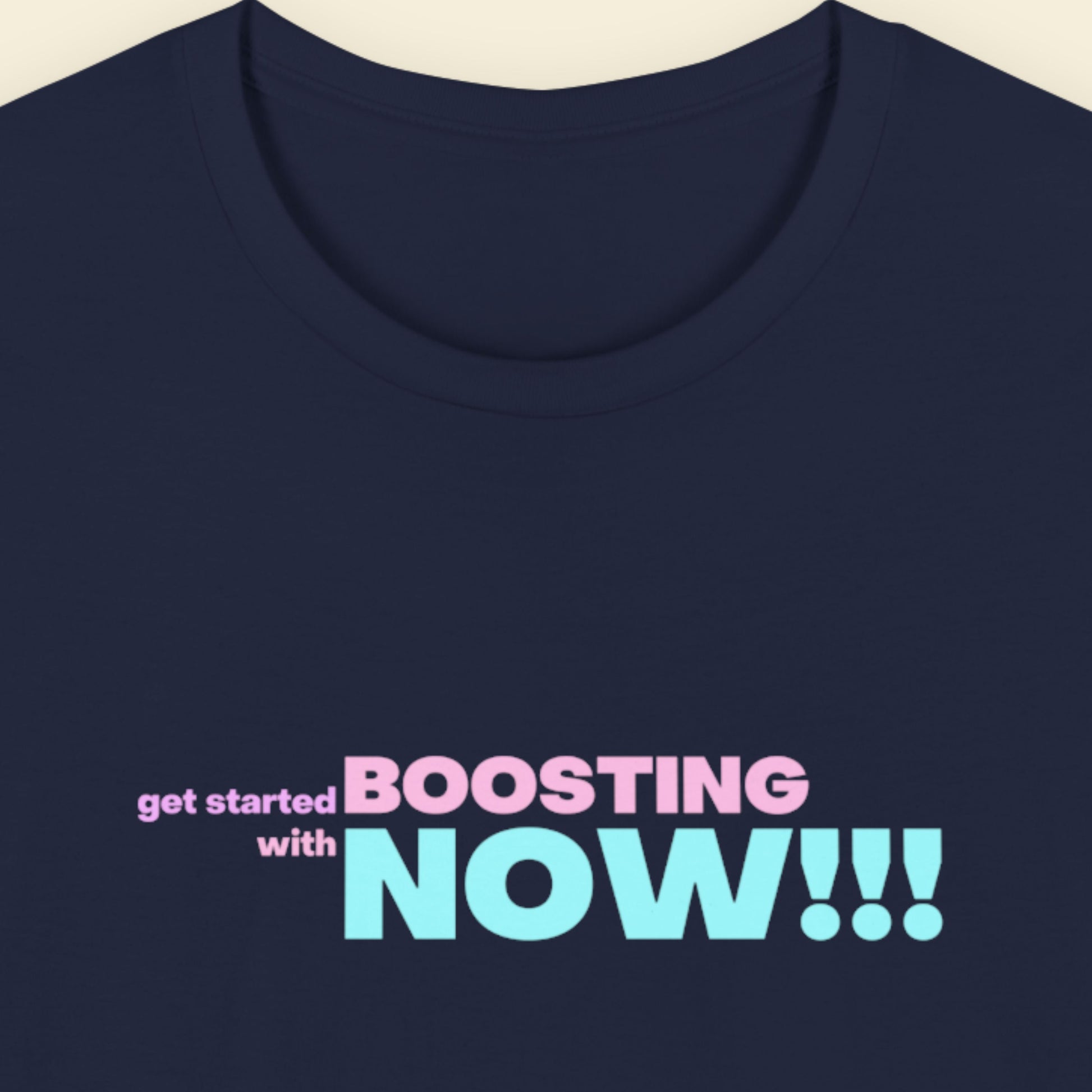 Navy blue t-shirt with humorous colorful text on a beige background.