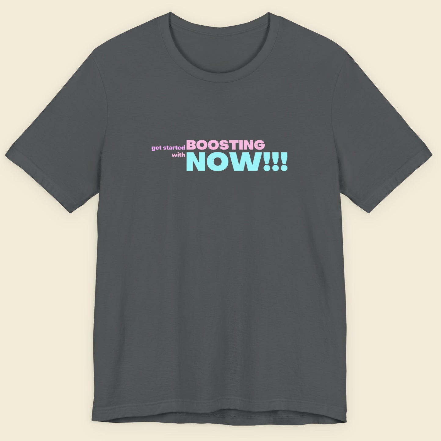 Dark grey t-shirt with humorous colorful text on a beige background.
