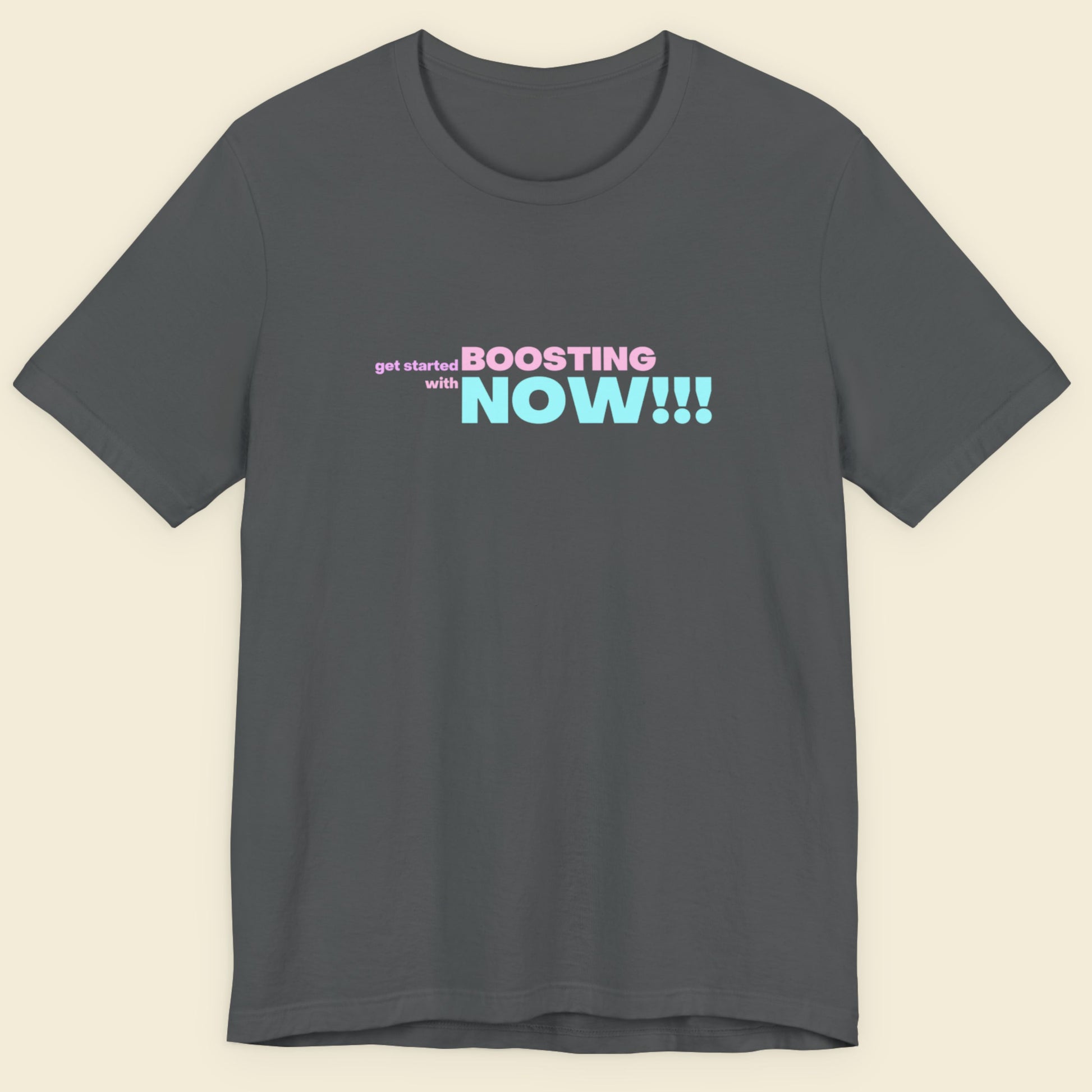 Dark grey t-shirt with humorous colorful text on a beige background.