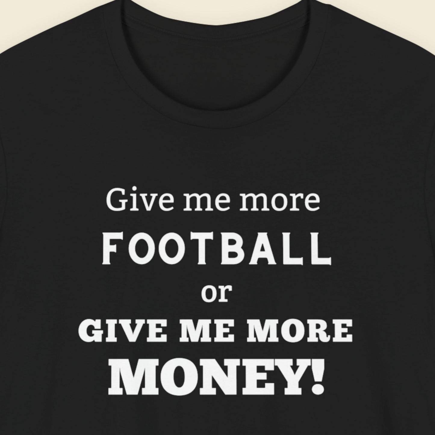Black t-shirt with humorous football text on a beige background.