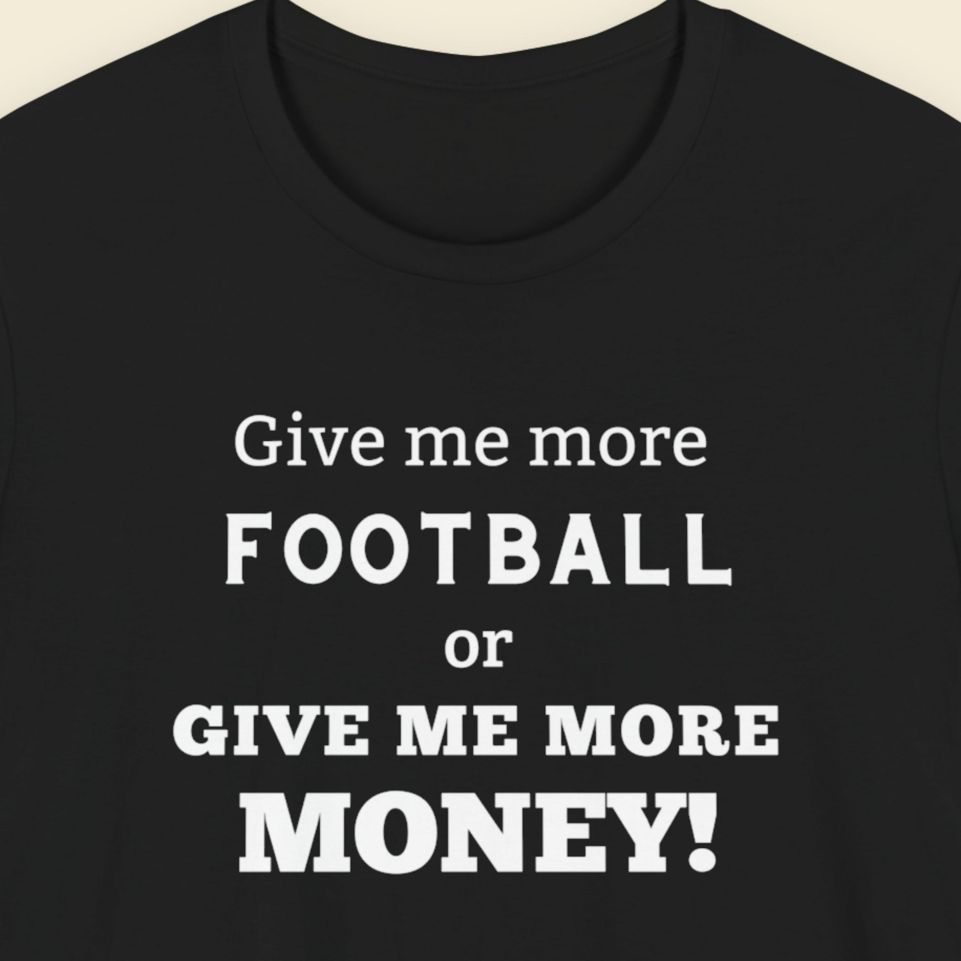Black t-shirt with humorous football text on a beige background.