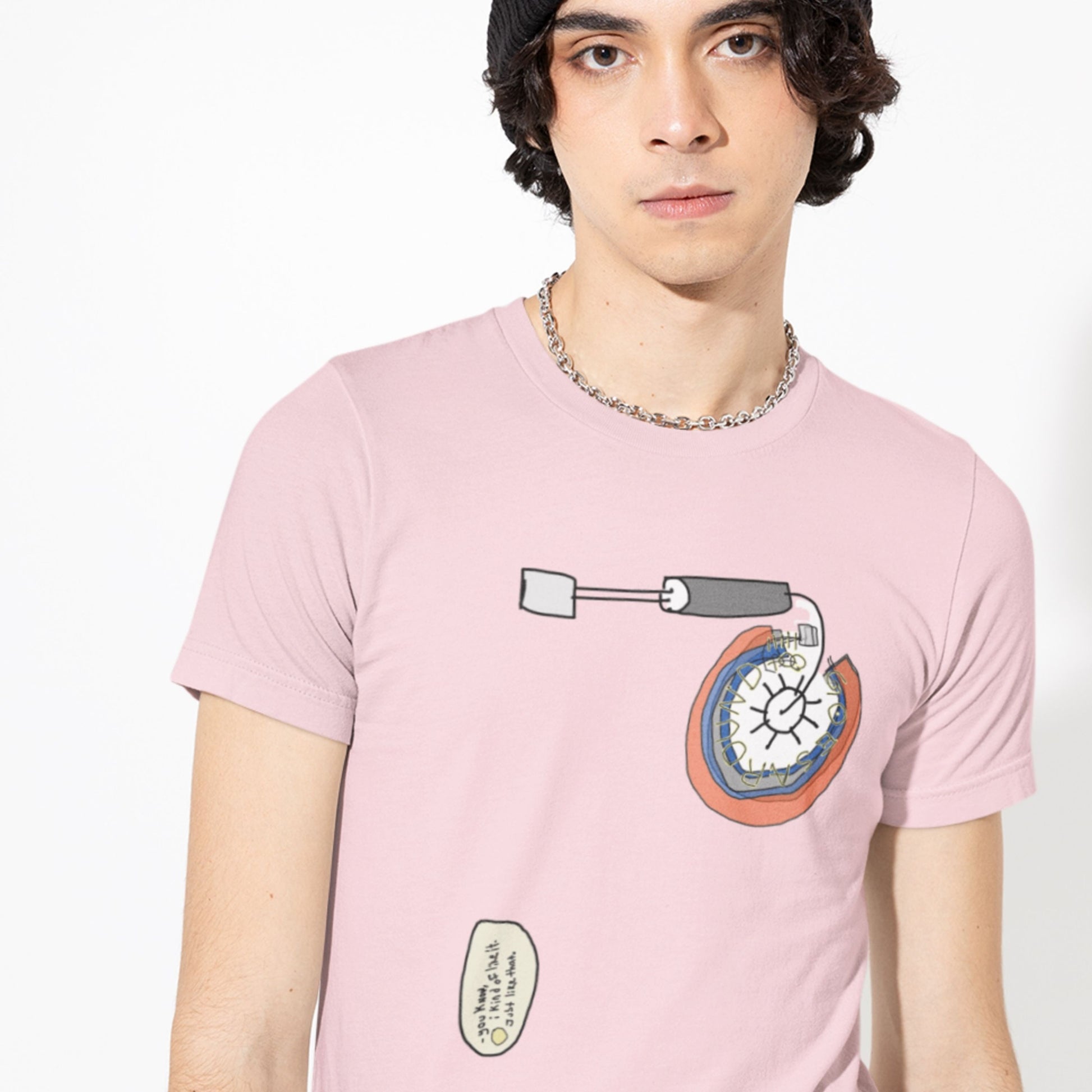 Person wearing a pink t-shirt with a graphic design on a white background.