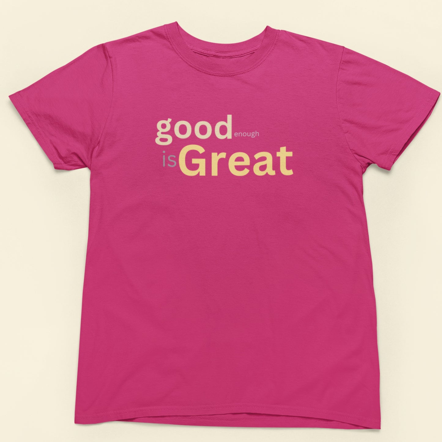 Pink t-shirt with 'good enough is Great' text on a beige background