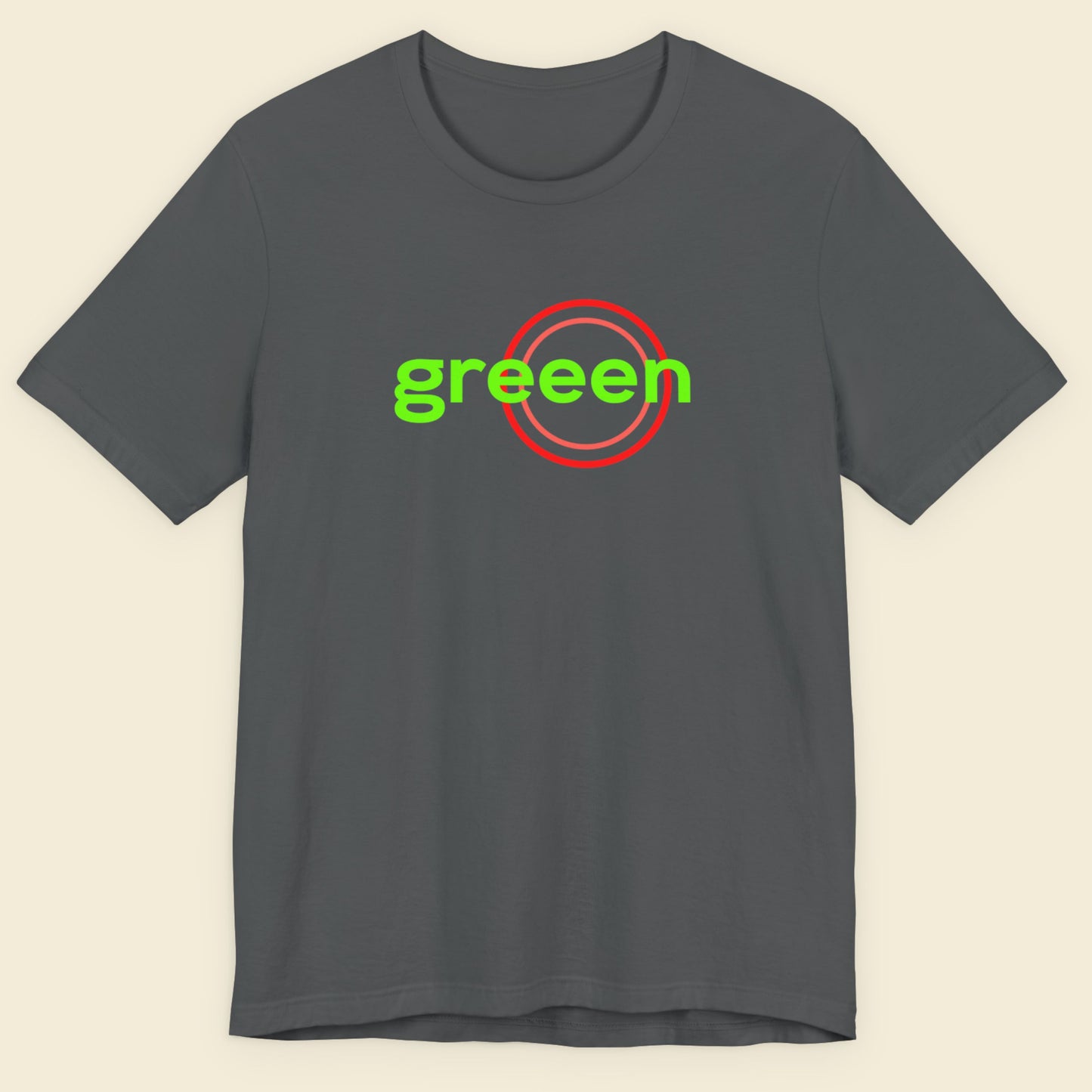 Gray t-shirt with 'greeen' text and red circle on a beige background.