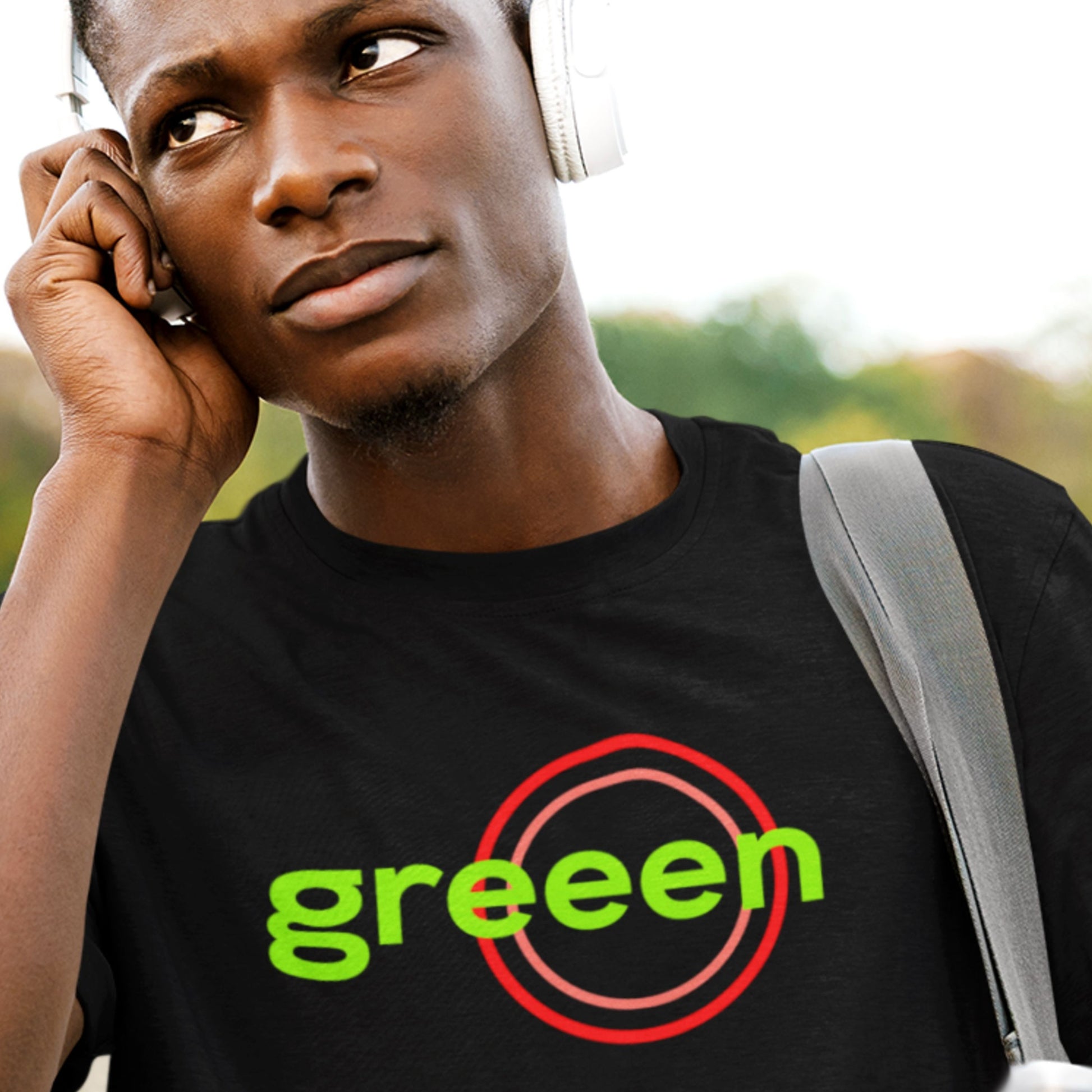 Man wearing a black t-shirt with humorous colorful text outside.
