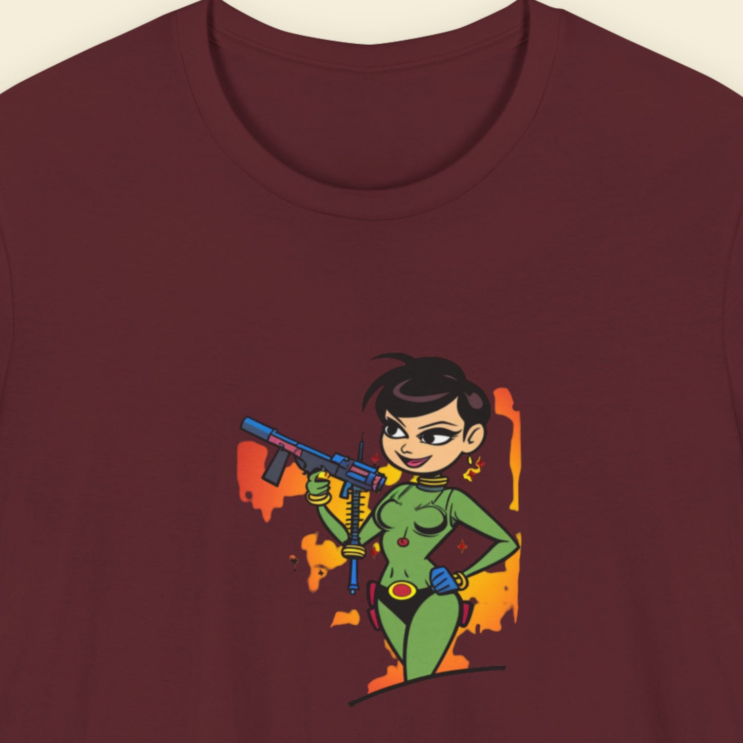 Maroon t-shirt with a fun, colorful cartoon illustration on a beige background.